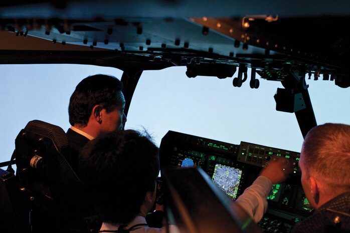 Naoto Sakaguchi, left, listens as an interpreter discusses various instruments Marines use to pilot an MV-22B Osprey tiltrotor aircraft Dec. 9 during an orientation tour at Marine Corps Air Station Futenma. Sakaguchi and other members of the Japan House of Representatives and Senate visited the air station to gain a better understanding of the Osprey. Sakaguchi is a member of the Japan House of Representatives, and the Marines are with Marine Medium Tiltrotor Squadron 262, Marine Aircraft Group 36, 1st Marine Aircraft Wing, III Marine Expeditionary Force. (U.S. Marine Corps photo by Sgt. Brian A. Marion/Released)