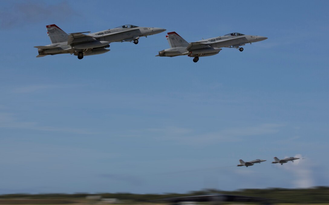 F/A-18C Hornets fly from Andersen Air Base, Guam, during exercise Forger Fury II, 5 December, 2013. Exercise Forger Fury II improves the aviation combat readiness of Marine Aircraft Group 12 and 1st Marine Aircraft Wing and simulates operations in a deployed environment. The Hornets are with Marine Fighter Attack Squadron 232, MAG-11, 3rd MAW, currently assigned to MAG-12, 1st MAW under the unit deployment program. (U.S. Marine Corps photo by Lance Cpl. Richard Currier/Released)