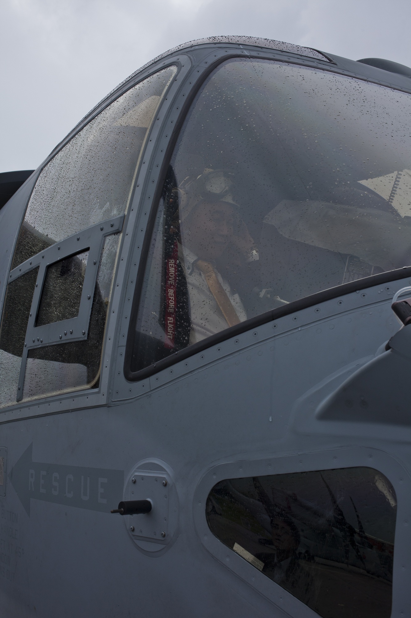 Hiromu Nakamaru places a cranial over his head while sitting in the cockpit of an MV-22B Osprey tiltrotor aircraft Dec. 9 during an orientation tour at Marine Corps Air Station Futenma. Nakamaru and other members of the Japan House of Representatives and Senate visited the air station to gain a better understanding of the Osprey. Nakamaru is a member of the Japan House of Representatives, and the Osprey is a part of Marine Medium Tiltrotor Squadron 262, Marine Aircraft Group 36, 1st Marine Aircraft Wing, III Marine Expeditionary Force.