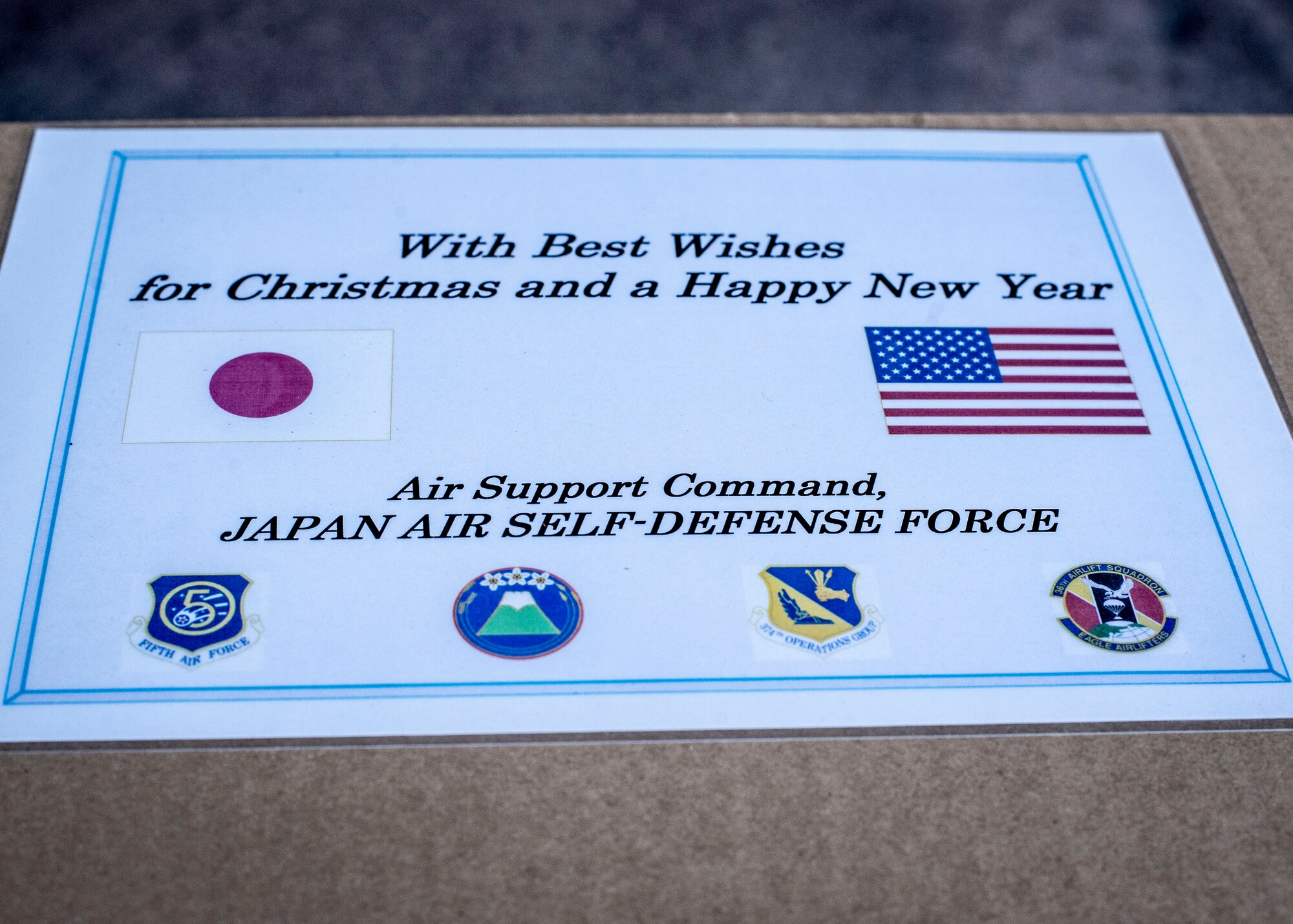 A message of goodwill adorns a box of donated goods provided by the Japan Air Self Defense Force at Yokota Air Base, Japan, Dec. 13, 2013. The goods will be dropped over several islands in the Federated States of Micronesia as a part of Operation Christmas Drops. (U.S. Air Force photo by Captain Raymond Geoffroy/Released)