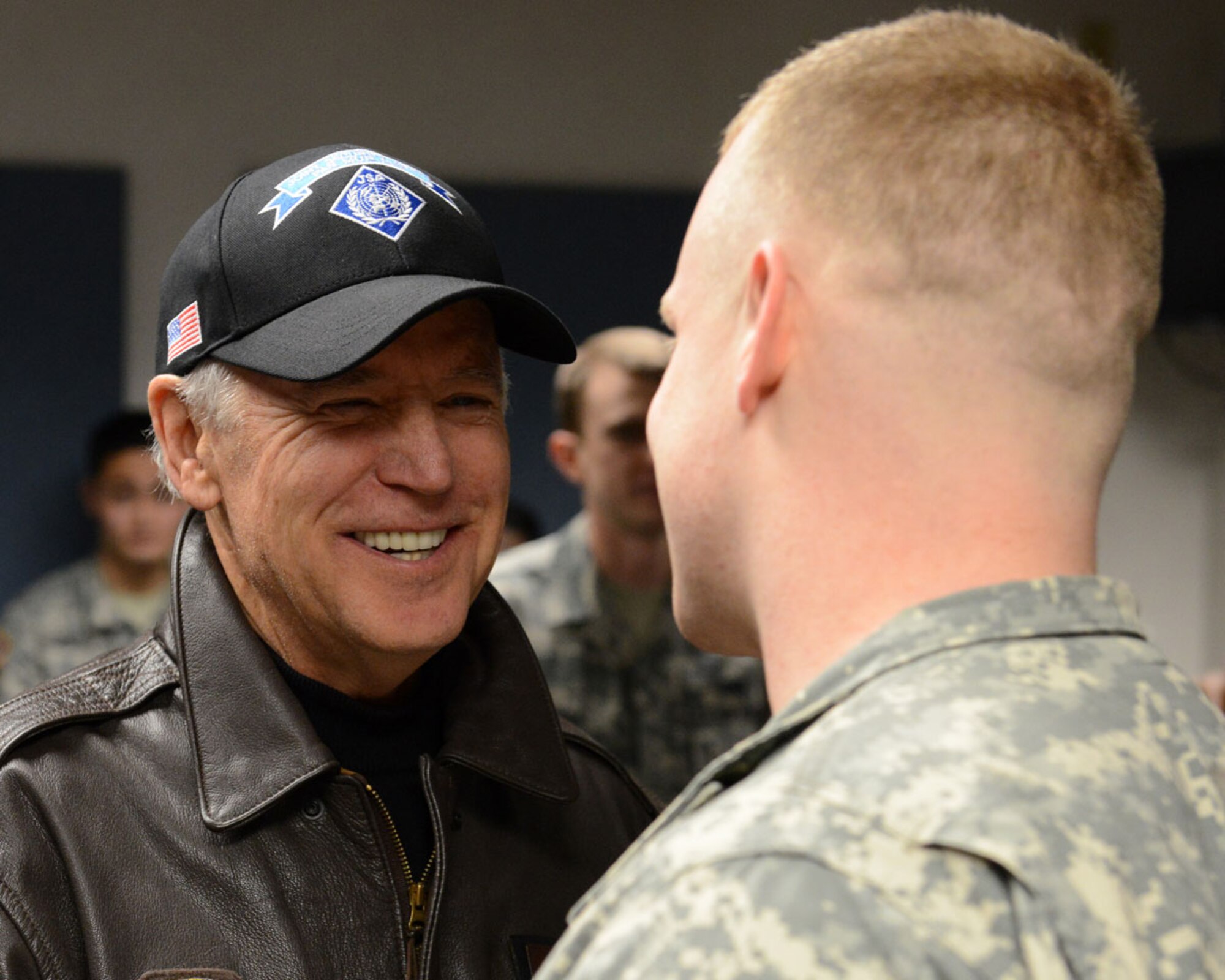 Vice President Joe Biden shares a laugh with Army 1st Lt. Andrew Judy, 1st Battalion (Airborne), 501st Infantry Regiment, during a meet-and-greet at the Joint Base Elmendorf-Richardson passenger terminal Dec. 7. Biden took the time to meet and take photos with more than 20 service members during his brief JBER visit. (U.S. Air Force photo/Staff Sgt. Blake Mize)