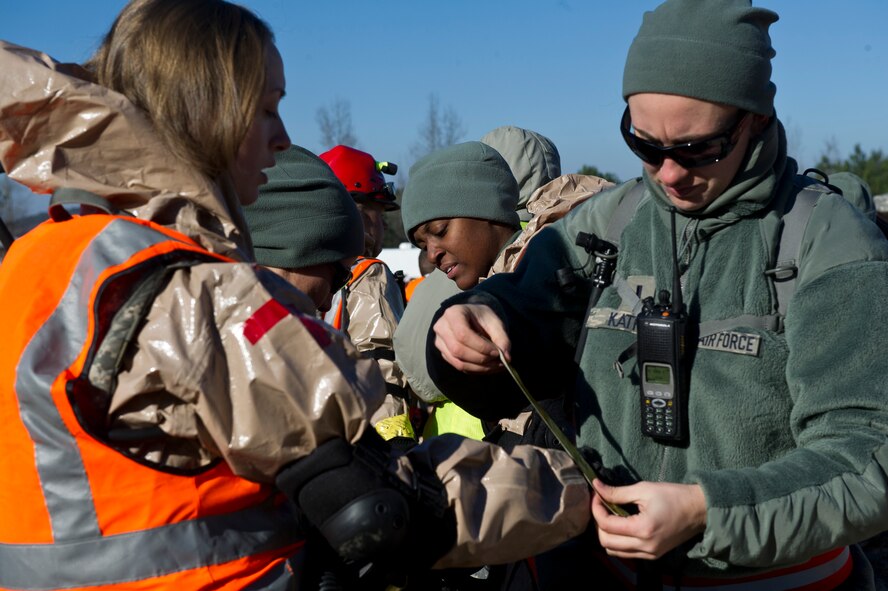 U.S. Air Force Staff Sgt. Briana Lee, 116th Medical Group, Georgia Air National Guard, receives assistance taping her search and extraction ensemble during the Region 4 Homeland Response Force (HRF) external evaluation at Pelham Range, Anniston, Ala., Dec. 12, 2013. The medical group from the 116th Air Control Wing, stationed at Robins Air Force Base, Ga., is a key component of the Region 4 HRF whose mission is to respond during disasters in the Southeast U.S. region. During the evaluation, the task force comprised of Air and Army National Guardsmen, responded to various scenarios that tested their ability to save lives and mitigate suffering in order to ensure their preparedness in the event of an incident or catastrophic event. (U.S. Air National Guard photo by Master Sgt. Roger Parsons/Released)