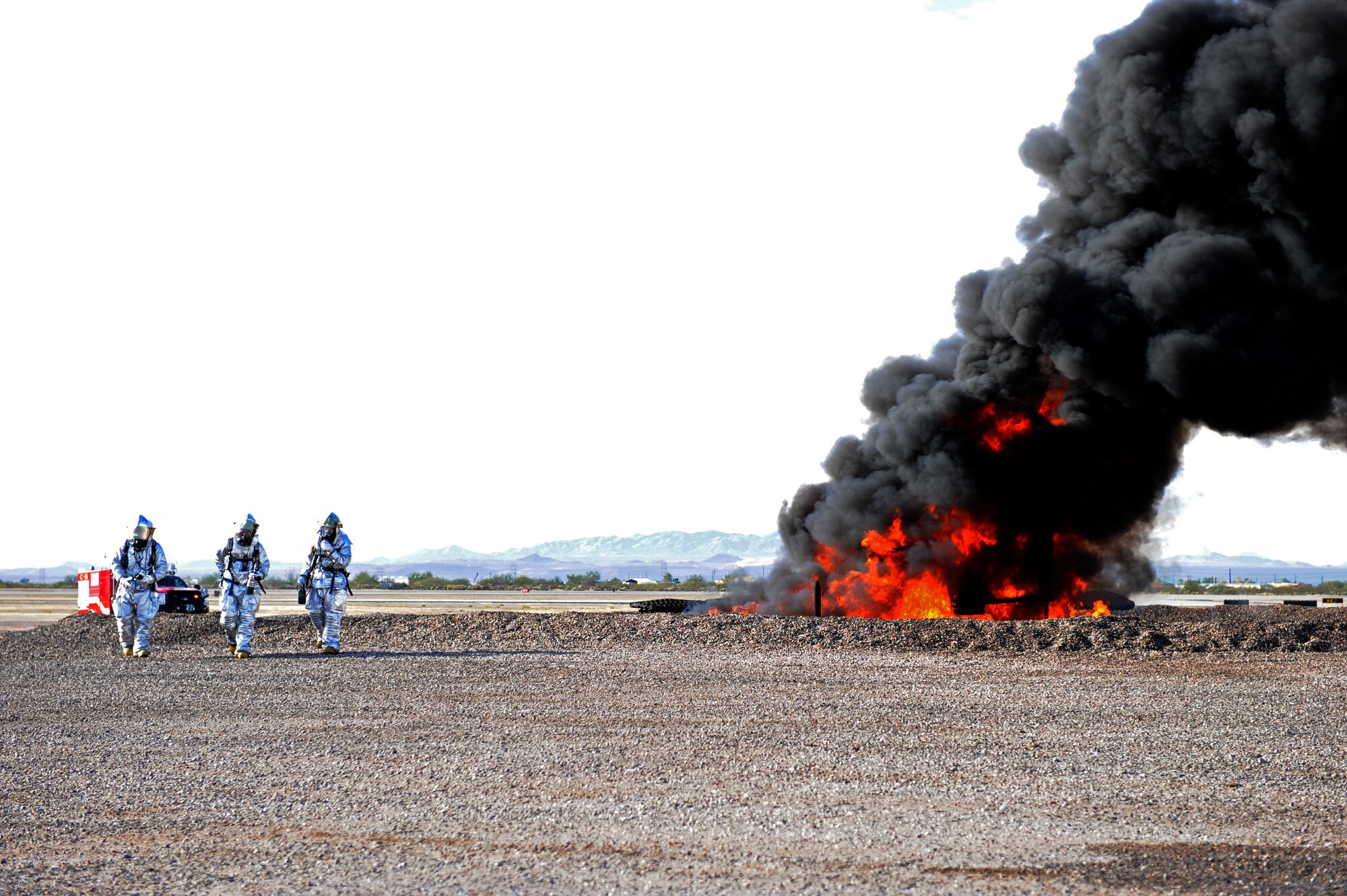 U.S. Air Force fire fighters from the 355th Civil Engineering Squadron ignite a controlled simulated aircraft fire during a training exercise at Davis-Monthan Air Force Base, Ariz. Dec. 10, 2013. The objective of this training exercise was to integrate and prepare approximately 20 fire fighters from Tucson International Airport and D-M in the event of a real-world aircraft fire. (U.S. Air Force photo by Airman 1st Class Chris Drzazgowski/Released)