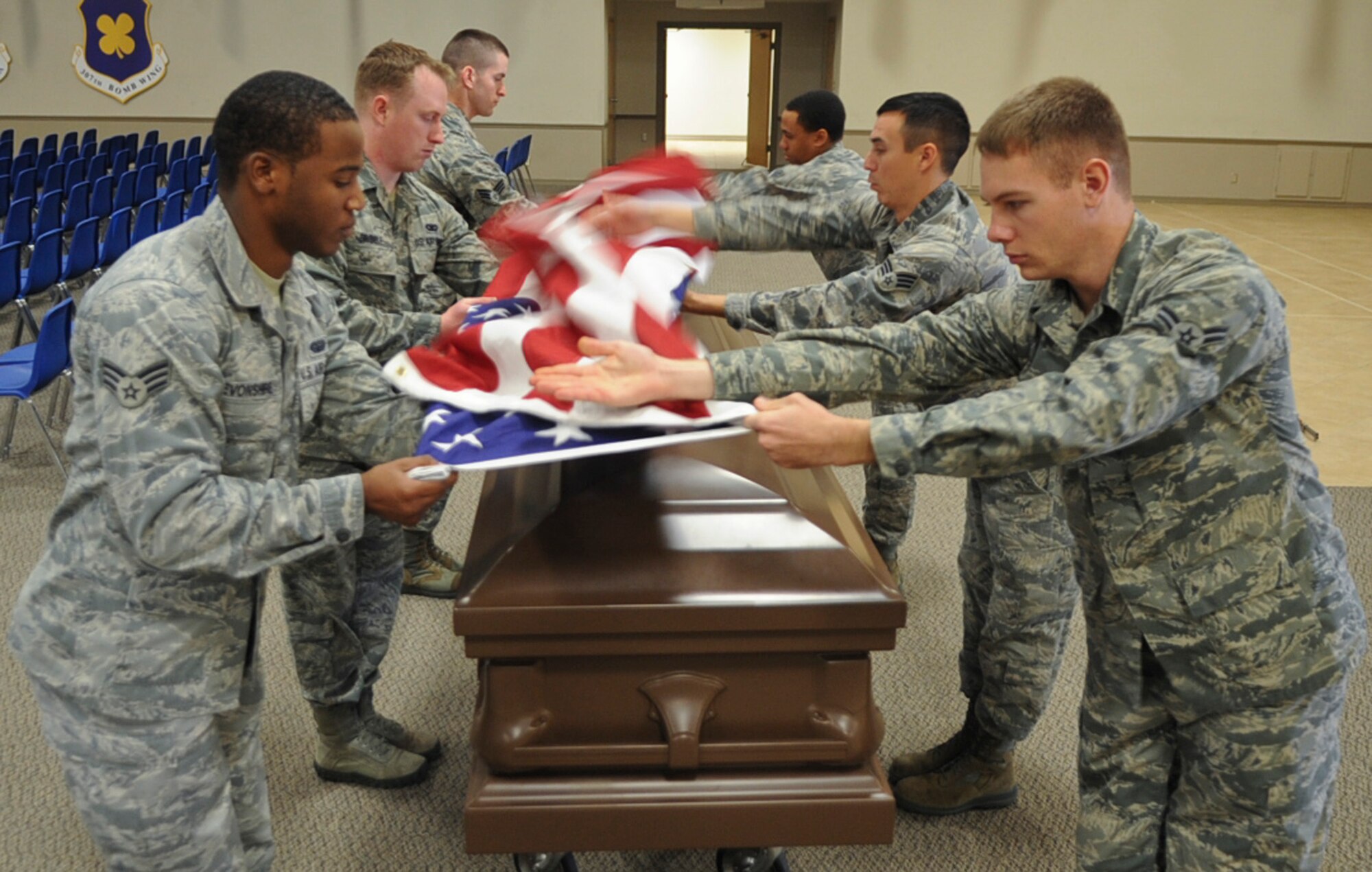 Airmen from the Barksdale Honor Guard practice a retired flag sequence fold on Barksdale Air Force Base, La., Dec. 12, 2013. The Honor Guard has covered more than 600 events in 2013 including funerals, posting and presenting of colors and retirements. (U.S. Air Force photo/Senior Airman Kristin High)