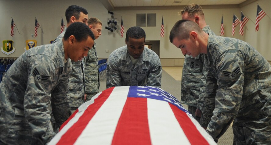 The Barksdale Honor Guard practices removing a casket from a hearse on Barksdale Air Force Base, La., Dec. 12, 2013. These Airmen train constantly to perfect their role as Honor Guardsmen, practicing drill and ceremony during their rotation, which can last from one to three months. (U.S. Air Force photo/Senior Airman Kristin High)
