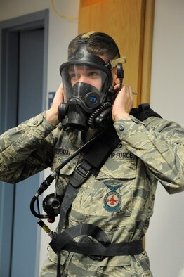 Senior Airman Peter Kurimai, 341st Civil Engineer Squadron firefighter, dons an oxygen mask during a classroom demonstration at the Malmstrom Fire Department on Dec. 5. Malmstrom firefighters respond to an average of 15 calls per week. (U.S. Air Force photo/Airman 1st Class Collin Schmidt)