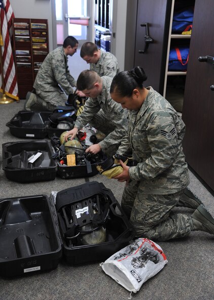 Senior Airman Michelle Smith, 341st Medical Operations Squadron bioenvironmental technician (right), inspects equipment with fellow technicians (left to right) Airman 1st Class Joel Rogel, Senior Airman Jonathan Bailey and Airman 1st Class Sean McLarnon. Smith was the Air Force Global Strike Command winner of the Outstanding Base Bioenvironmental Engineering Airman of the Year award.  (U.S. Air Force photo/Senior Airman Cortney Paxton)