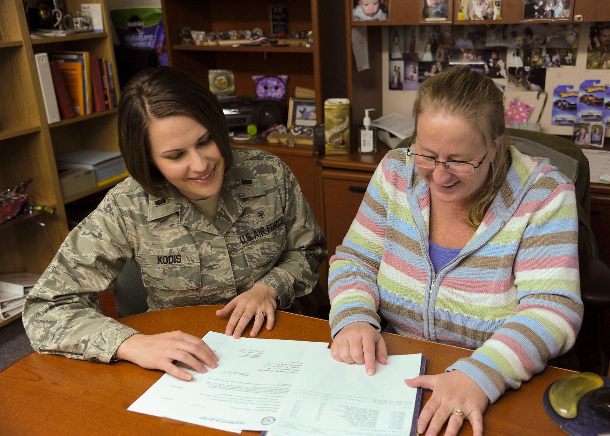 1st Lt. Patricia Kodis, 341st Medical Support Squadron Resource Management Flight commander (left), and Cammie Maloney, 341st MDSS third-party collections uniform business objects manager, look over paperwork together Dec. 3. Both were Air Force Global Strike Command winners of Air Force Medical Service Awards. Kodis won the U.S. Air Force Young Health Care Administrator of the Year, and Maloney won the Outstanding Civilian of the Year – Medical Service Corps Civilian.  (U.S. Air Force photo/Senior Airman Cortney Paxton)