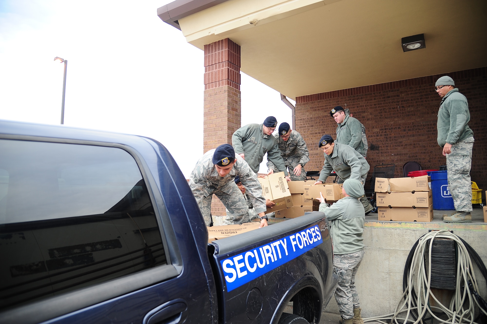 Airmen from the 509th Security Forces Squadron load frozen turkeys Nov. 15, 2013, at Whiteman Air Force Base, Mo. First sergeants provided 300 baskets full of Thanksgiving foods to Airmen around base to help them have a great holiday. (U.S. Air Force photo by Master Sgt. Matt Osborn/Released)