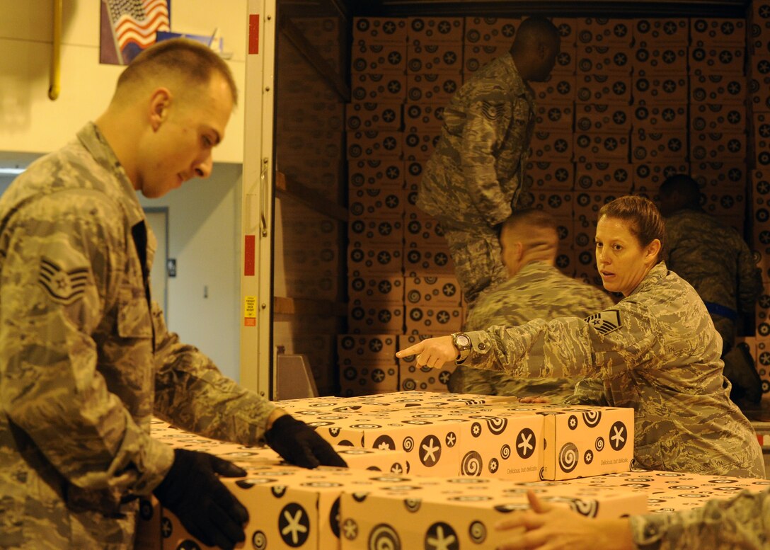 Airmen from the 89th Aerial Port Squadron offload and palletize more than 10,000 donated Georgetown Cupcakes at Joint Base Andrews, Md., Dec. 6, 2013. The local bakery partnered Gen. Martin Dempsey, 18th Chairman of the Joint Chiefs of Staff to send these pastries to service members overseas. (U.S. Air Force photo/Staff Sgt. Nichelle Anderson)