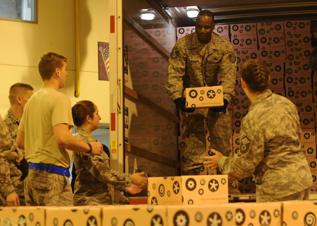 Airmen from the 89th Aerial Port Squadron offload and palletize more than 10,000 donated Georgetown Cupcakes at Joint Base Andrews, Md., Dec. 6, 2013. The local bakery partnered Gen. Martin Dempsey, 18th Chairman of the Joint Chiefs of Staff to send these pastries to service members overseas. (U.S. Air Force photo/Staff Sgt. Nichelle Anderson)