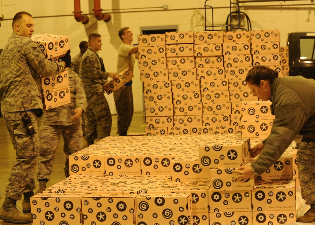 Airmen from the 89th Aerial Port Squadron offload and palletize more than 10,000 donated Georgetown Cupcakes at Joint Base Andrews, Md., Dec. 6, 2013. The local bakery partnered Gen. Martin Dempsey, 18th Chairman of the Joint Chiefs of Staff to send these pastries to service members overseas. (U.S. Air Force photo/Staff Sgt. Nichelle Anderson)