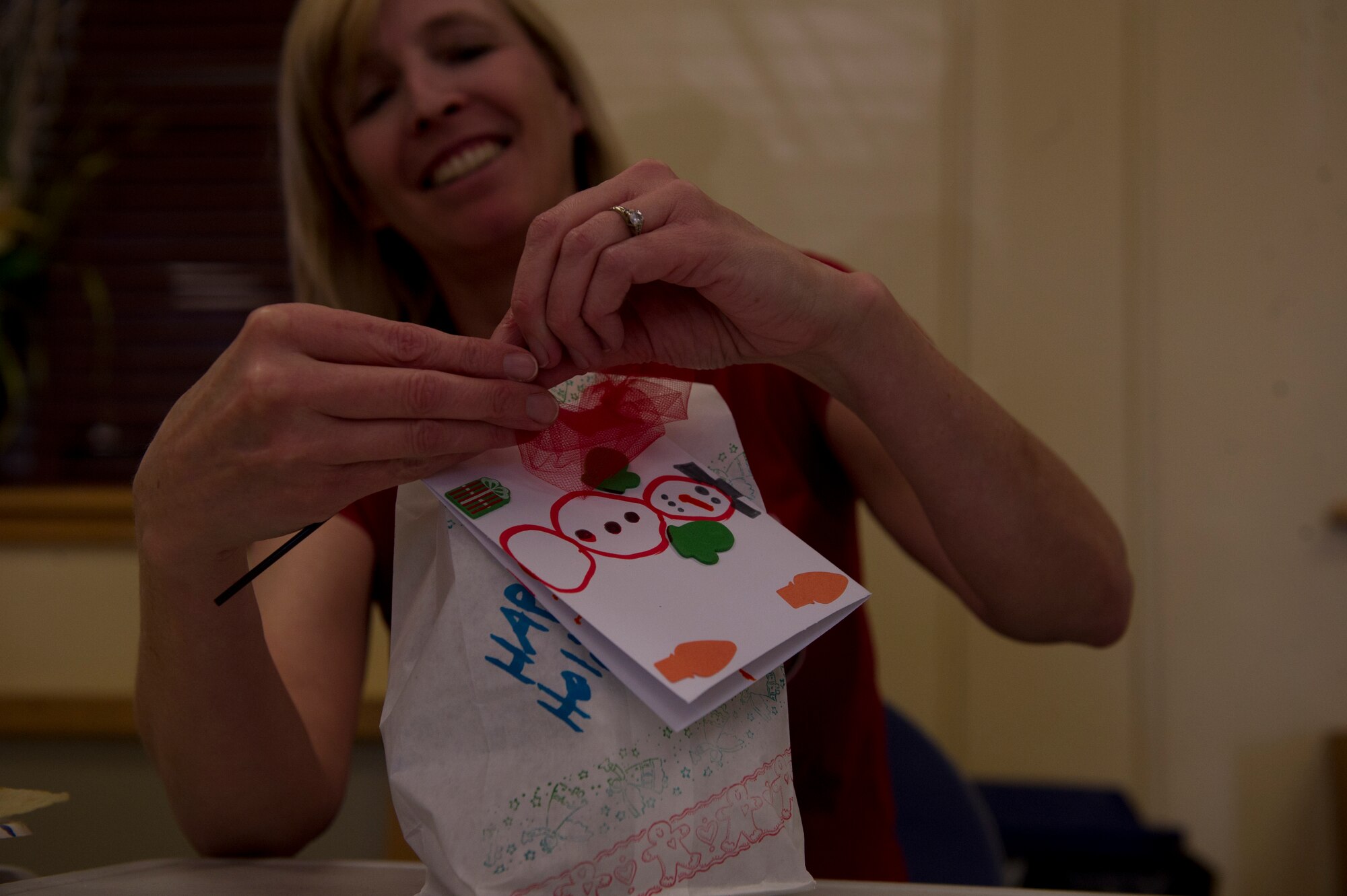 Vicki Croft, wife of Col. Andrew Croft, 49th Wing commander, prepares a package of cookies to be distributed to Airmen living in the dorms at Holloman Air Force Base N.M., Dec. 9. “It’s to give the Airmen who are away from home for the first time a little taste of home during the holiday season,” said Croft. Members of Team Holloman and the local community baked cookies to be given to Airmen living in the dorms. (U.S. Air Force photo by Airman 1st Class Chase Cannon/Released)