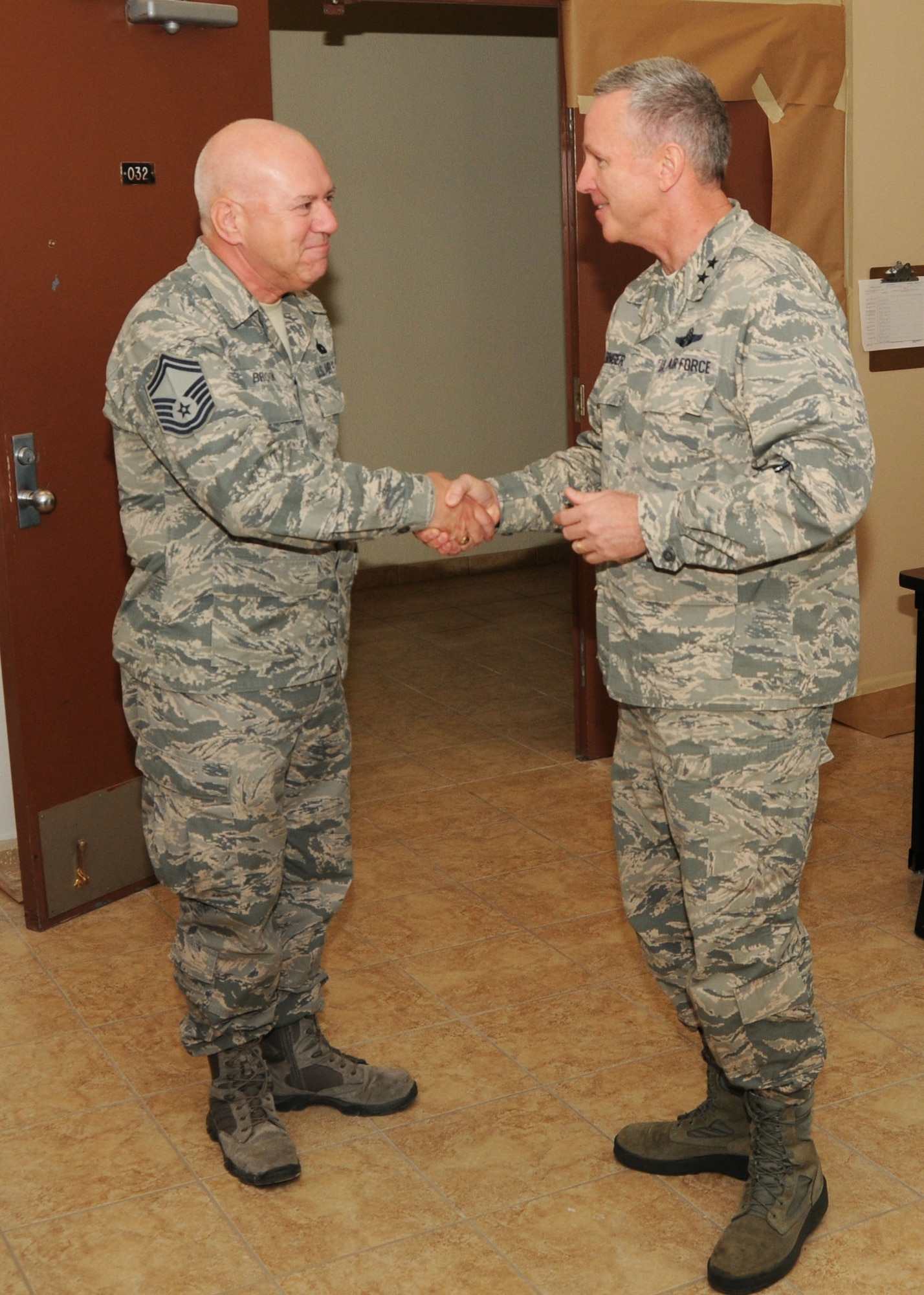 Maj. Gen. William Binger, 10th Air Force Commander, shakes hands and gives a coin to Senior Master Sgt. Stephen Brook, 944th Logistics Readiness Squadron Superintendent of Vehicle Operations, Dec. 10 at Luke Air Force Base, Ariz. (U.S. Air Force photo taken by Tech. Sgt. Louis Vega Jr.)