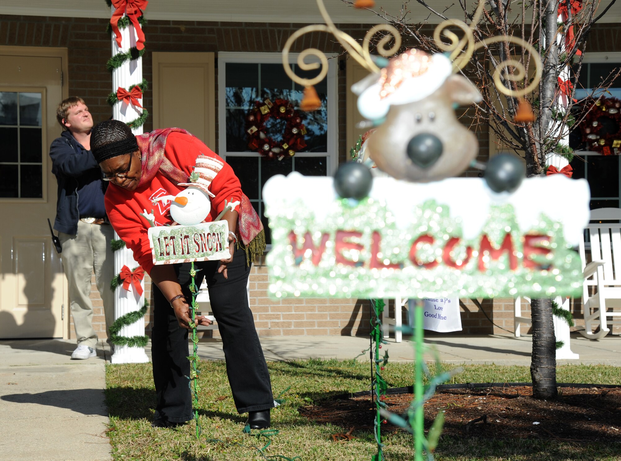 Mike Helle and Chris Cannedy, local Biloxi business employees, decorate the Fisher House for Christmas Dec. 12, 2013, at Keesler Air Force Base, Miss.  Every year a local business volunteers to decorate the house. The Fisher House Foundation is best known for a network of comfort homes where military and veterans’ families can stay at no cost while a loved one is receiving treatment.  (U.S. Air Force photo by Kemberly Groue)