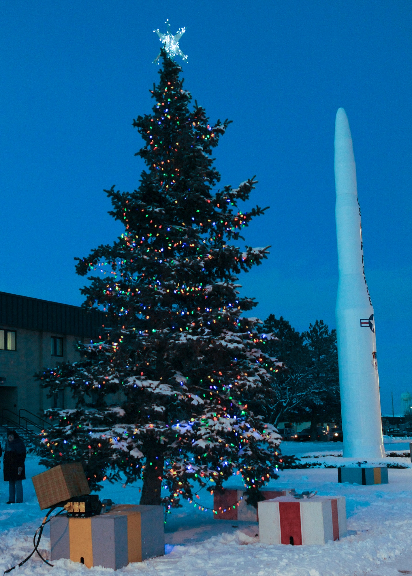 Pictured is the lit tree in front of Malmstrom's Bldg. 1191. The tree will continue to glow with these lights until New Year’s Day.  (U.S. Air Force photo/Senior Airman Cortney Paxton)