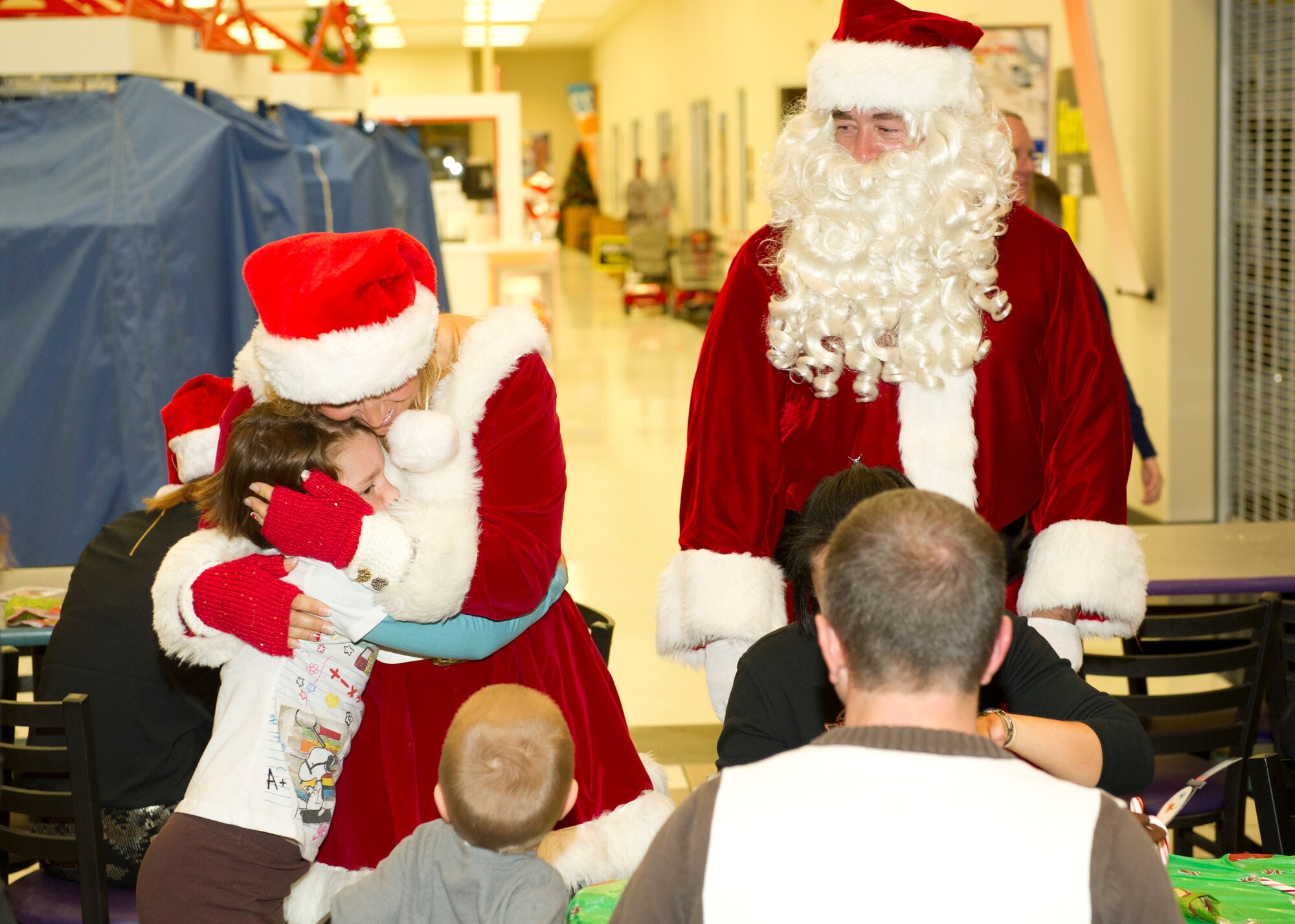 Children of deployed and remote military members enjoy a night with Santa and Mrs. Claus during the annual Jingle Bell Banquet where they were given a free holiday meal and presents at the Holloman Air Force Base Exchange N.M., Nov. 7. This event was a joint community effort with the Exchange, the Airman and Family Readiness Center, the German Air Force, the Key Spouses of the 6th Reconnaissance Squadron, the Test Group, the 4th Space, Materiel Maintenance Squadron and gift donations from David Overstreet, owner of Overstreet Taekwondo in Alamogordo, N.M.