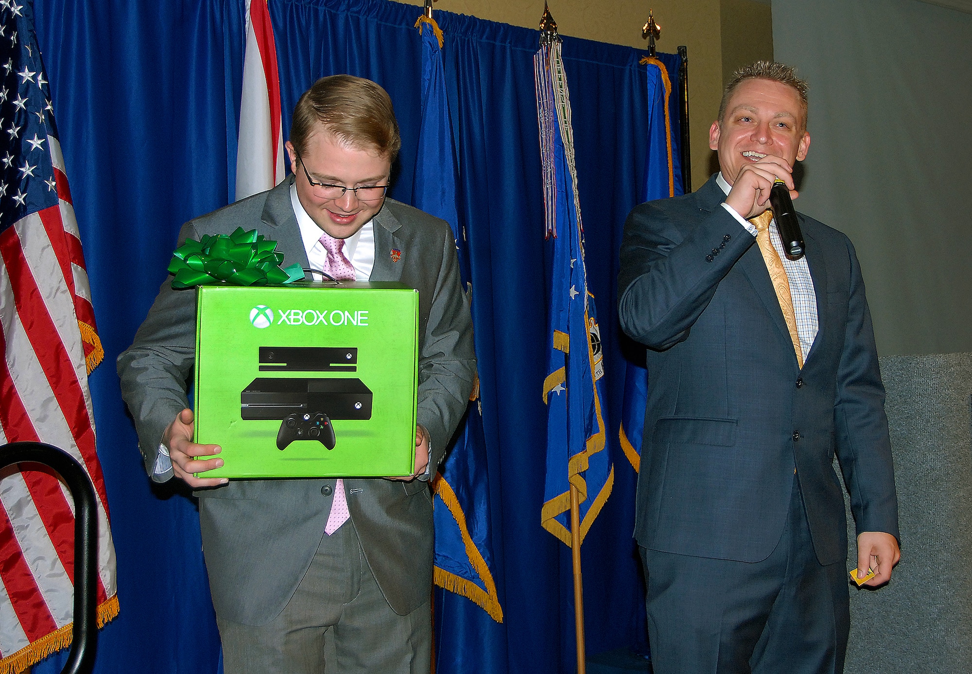 Cutline:  Senior Airman Carl Ross holds up the grand door prize of the evening as Anniversary Committee Chairperson Master Sgt. Jon Butterbaugh calls out the winning ticket number.  
(Air Force photo by Gene H. Hughes)
