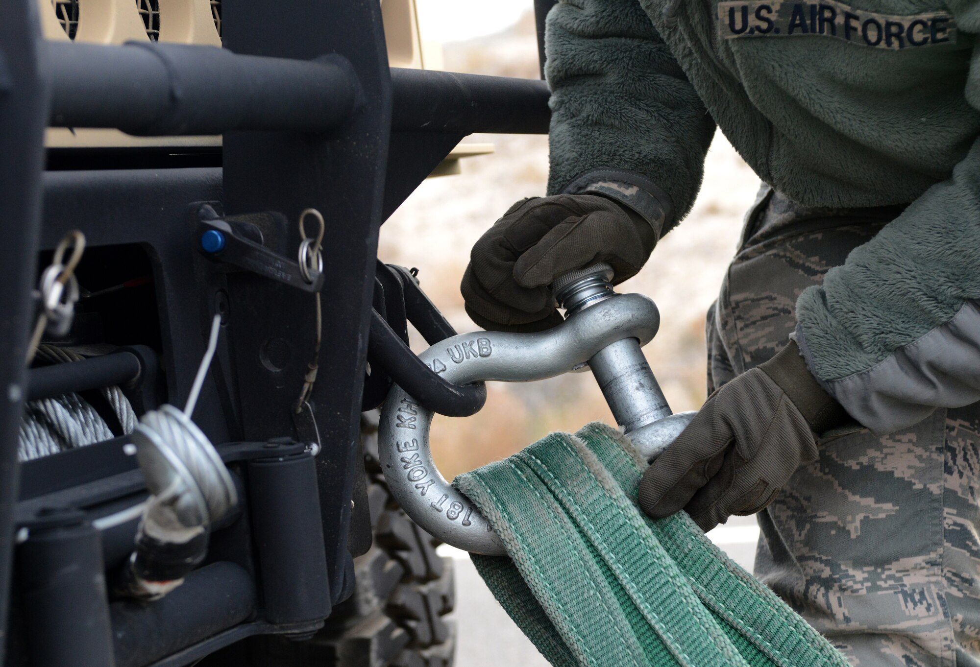 U.S. Air Force Airman 1st Class Ethan Croce, 366th Logistic Readiness Squadron vehicle operator, directs a vehicle into a towing position in order to flat tow a humvee during Convoy Operations Readiness Training, Dec. 6, 2013, near Mountain Home Air Force Base, Idaho. During the training Airmen learned how to flat tow and recover a vehicle after it sustained damage. (U.S. Air Force photo/Senior Airman Caitlin Guinazu/Released)