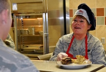 PETERSON AIR FORCE BASE, Colo. Chief Master Sgt. Sally Arnold joined other senior leaders in helping with the Aragon dining facility’s Saturday lunch rush during the 302nd Airlift Wing’s Unit Training Assembly Dec. 7 here. Arnold, chief of civil engineering operations, retires Dec. 13 after 36 years of service. (U.S. Air Force photo/Master Sgt. Daniel Butterfield) 