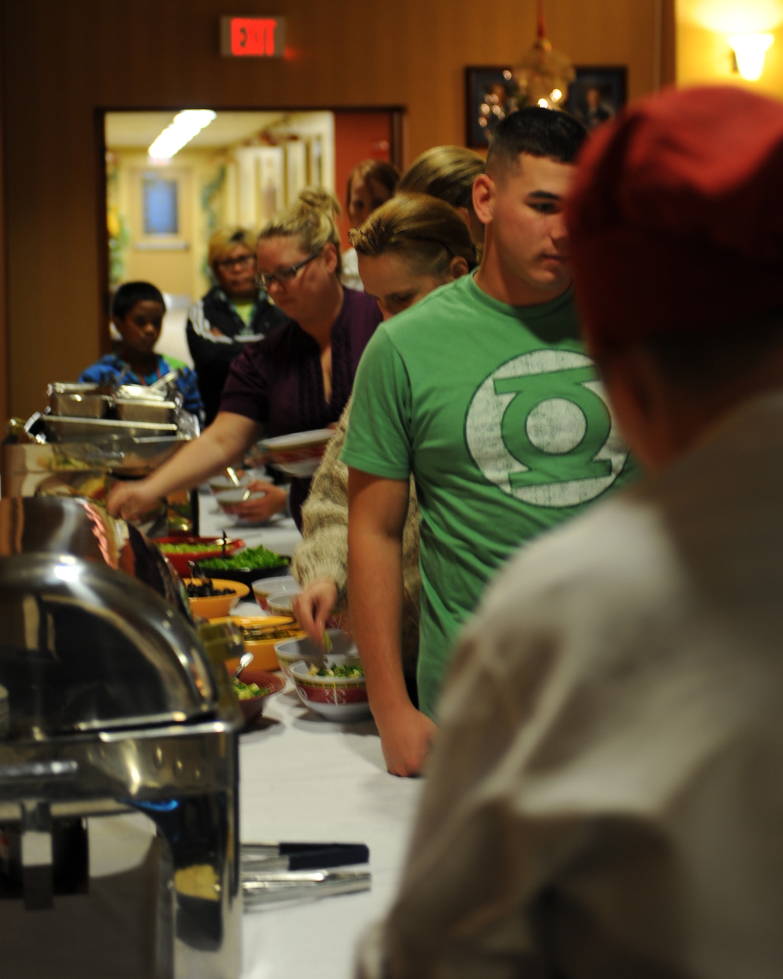 Attendees of the “Pasta and Pajama Holiday Celebration” prepare their bowls of pasta at the Mirage Club, Davis-Monthan Air Force Base, Ariz., Dec. 10, 2013.  D-M members were invited to wear their pajamas, allowing them to relax while eating dinner and watching a movie.  (U.S. Air Force photo by Airman 1st Class Chris Massey/Released)