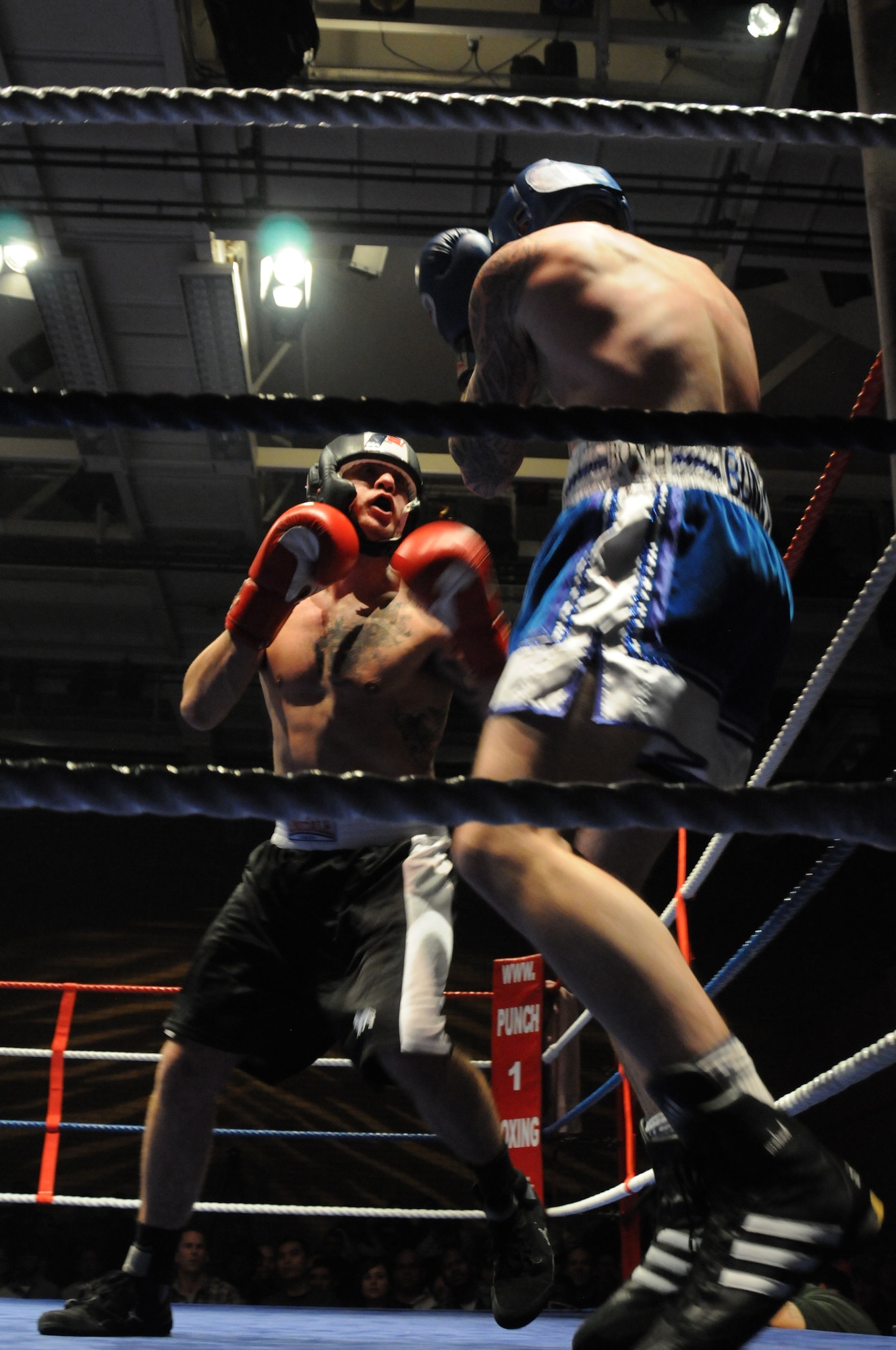 U.S. Air Force Airman 1st Class Dominic Sirianni, 748th Aircraft Maintenance Squadron, backs his opponent into a corner during a boxing match Dec. 7, 2013, in Huntingdon, England. The match was one of several held during an independent event that pitted U.S. Airmen against U.K. fighters. The event was held to raise funds for several charities. (U.S. Air Force photo by Tech. Sgt. Neal X. Joiner/Released)