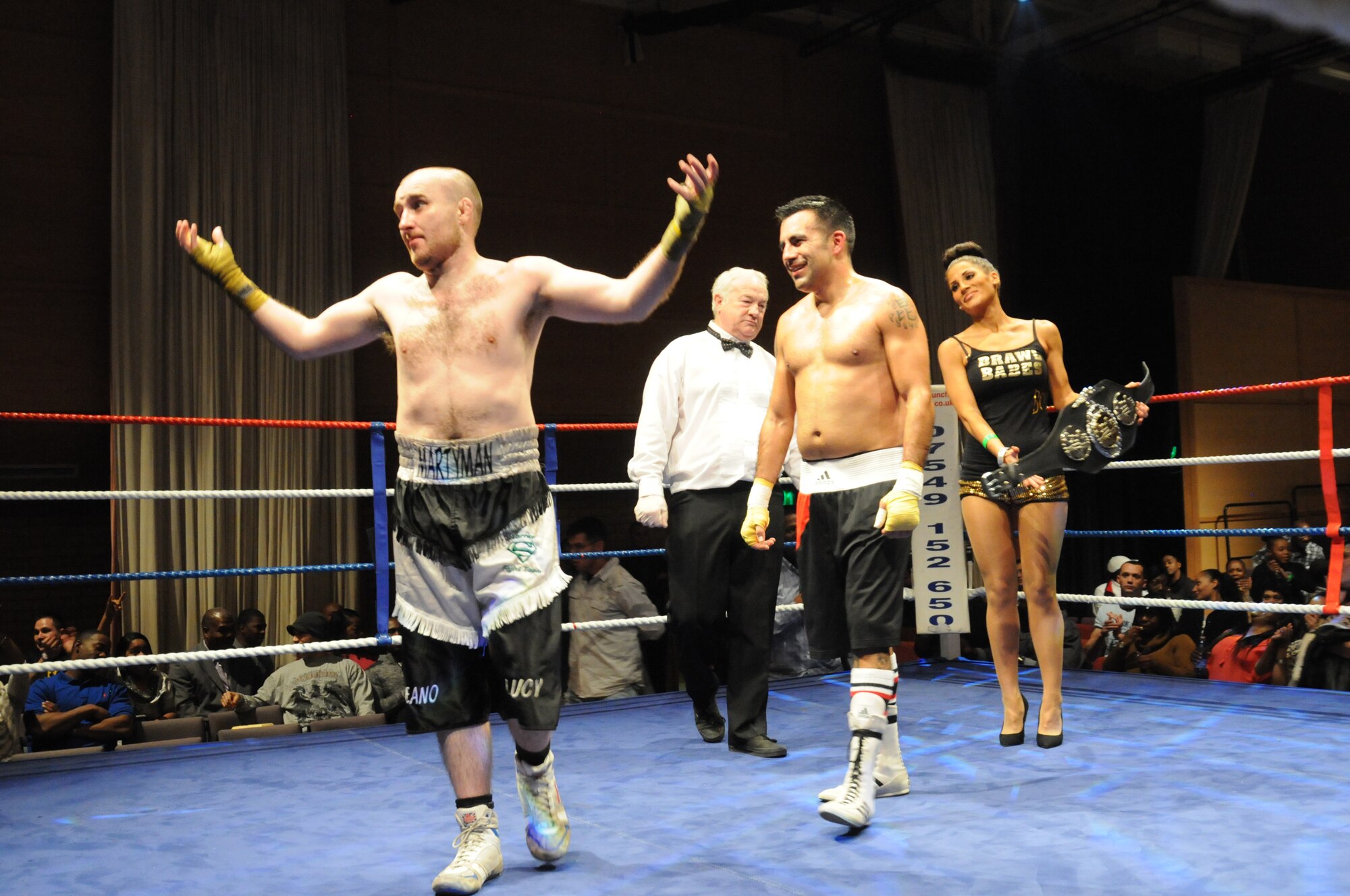 Marty Kayes, left, raises his hands after the judge’s ruling is read following his boxing-match loss to U.S. Air Force Tech. Sgt. Richard Mora, 100th Aircraft Maintenance Squadron from Oceanside, Calif., for the light middle weight title Dec. 7, 2013, in Huntingdon, England. The match was one of several held during an independent event that featured U.S. Airmen competing against U.K. fighters. The fights raised money for several charities. (U.S. Air Force photo by Tech. Sgt. Neal X. Joiner/Released)