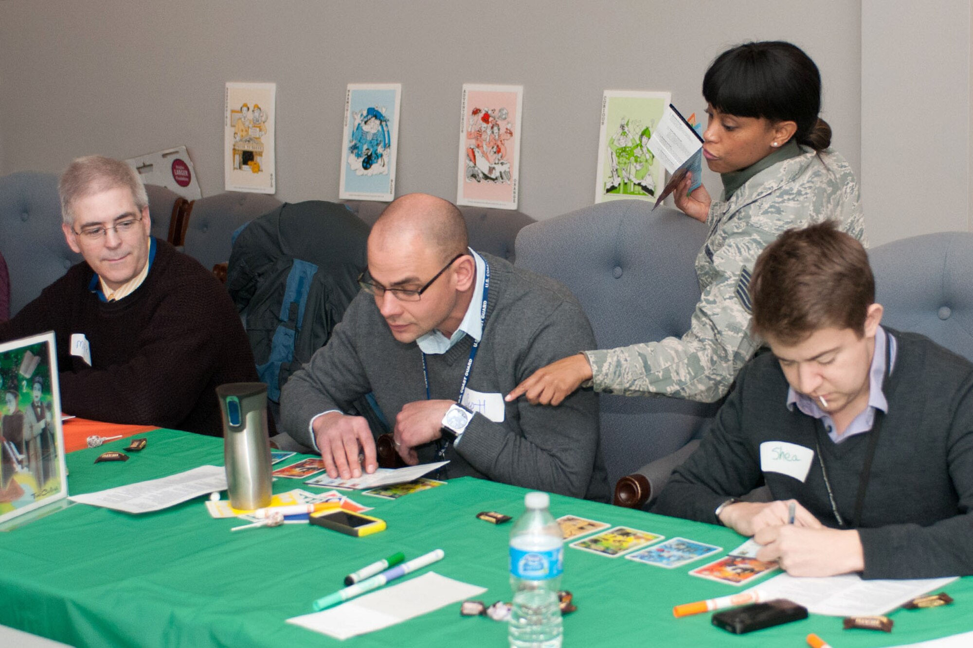 Tech. Sgt. Mary Williams, Equal Opportunity NCO in charge, assists (left to right), Mark Stevens, Scott Lapinski, Shea Hammond identify their “true colors” as part of a wingman event. True Colors is a personality identification that is created to categorize four basic learning styles using the colors blue, orange, gold and green. True Colors distills the elaborate concepts of personality into a user-friendly, practical tool used to foster healthy productive relationships. (U.S. Air Force photo by Rick Berry)