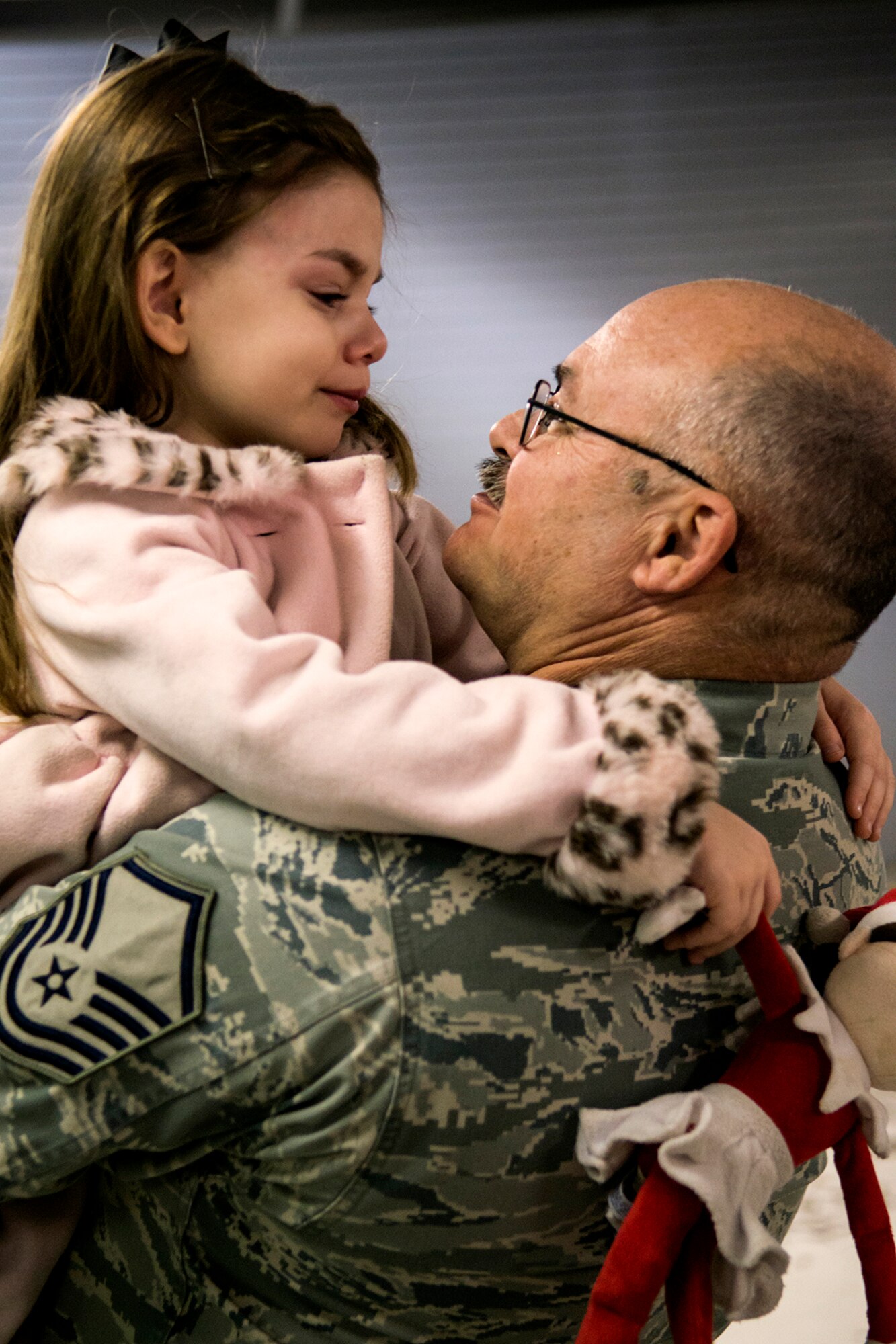 U.S. Air Force Master Sgt. Bruce Jester gets a teary-eyed hug from his granddaughter, Angel, at the end of his retirement ceremony on Dec. 7, 2013, Barksdale Air Force Base, La. Jester was a munitions controller assigned to the 307th Maintenance Squadron and retired after 26 years of military service. (U.S. Air Force photo by Master Sgt. Greg Steele/Released)