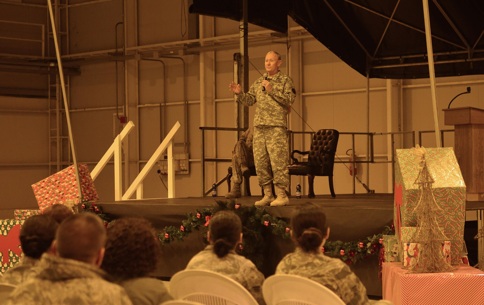 Aviano Airmen listen intently as Army Gen. Martin Dempsey, Chairman of the Joint Chiefs of Staff, answers questions during an all call, Dec. 11, 2013, at Aviano Air Base, Italy. The highest ranking military officer in the armed forces hosted the all-call to answer questions Team Aviano Airmen had regarding pertinent to Air Force and military concerns. (U.S. Air Force photo/Senior Airman Briana Jones)