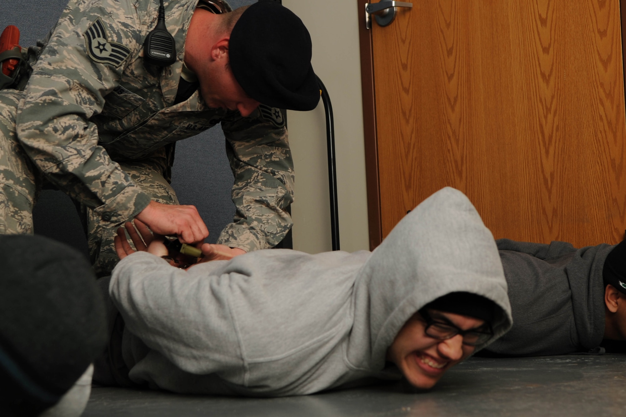 ALTUS AIR FORCE BASE Okla. – U.S. Air Force Staff Sgt. Arthur Hanus, 97th Security Forces Squadron response force leader, handcuffs a suspect during an active-shooter exercise Dec. 11, 2013. The exercise tested first responders as well as medical group personnel on their response in the event of an active shooter. (U.S. Air Force photo by Airman 1st Class Klynne Pearl Serrano/Released)