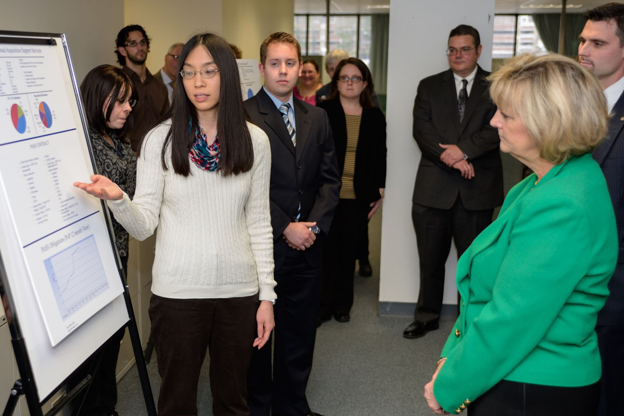 Air Force Life Cycle Management Center Executive Director Patsy Reeves listens as Diana Tien, a contracts specialist intern, discusses the Professional Acquisition Support Services, or PASS program, during her visit here Dec. 9-11. While at Hanscom, Reeves also met with Hanscom’s PEOs, toured the base with 66th Air Base Group leadership and received overviews of Federally Funded Research and Development Center efforts managed by Hanscom, as well as a tour of MIT’s Lincoln Laboratory. (U.S. Air Force photo by Rick Berry)