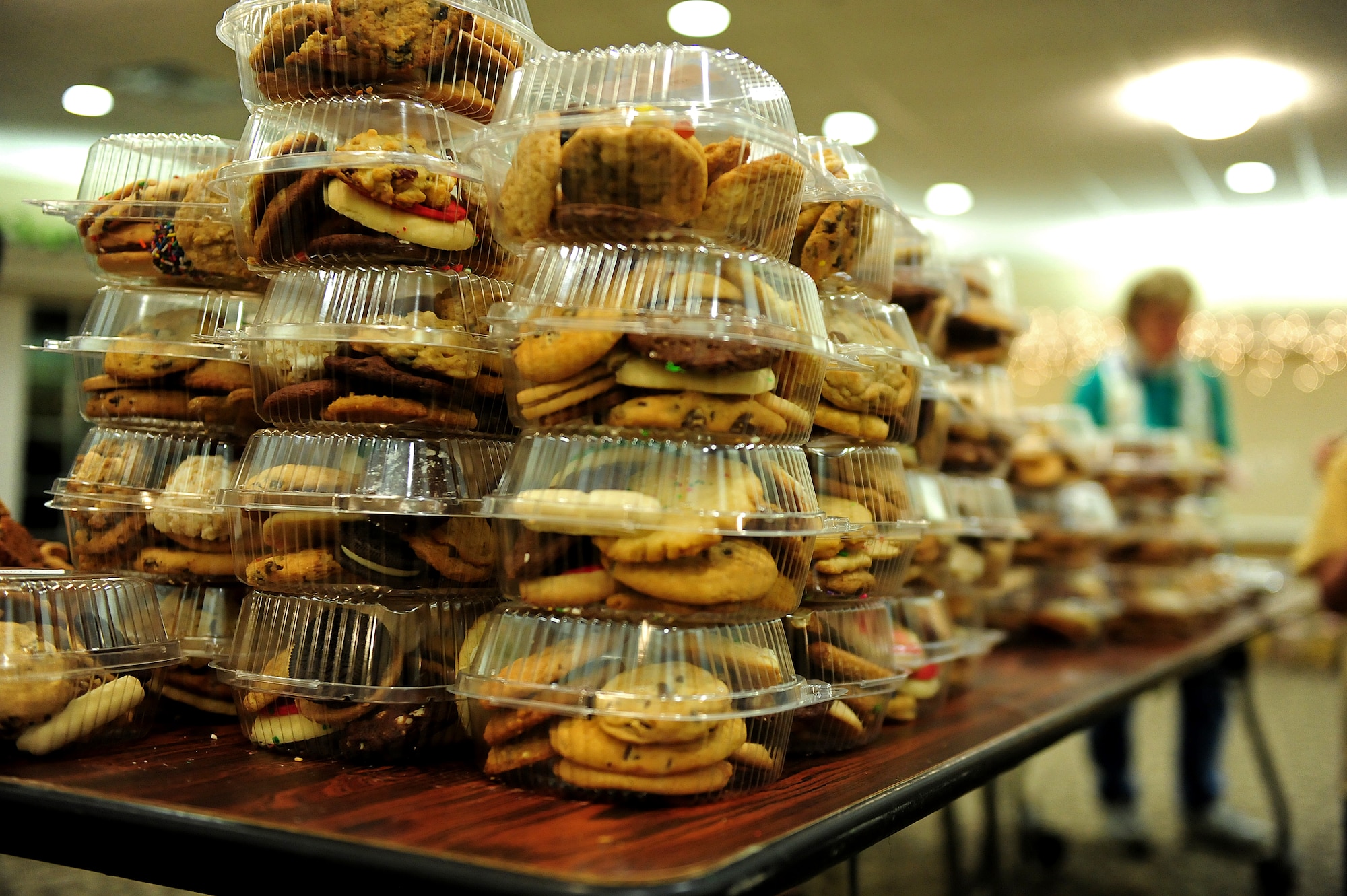 Each year, the Officer and Civilian Spouses’ Club, a private organization which helps military spouses get involved with the base community, hosts an Airman Cookie Drive for members of the community to donate baked goods to bring holiday cheer to Airmen living in the dorms.  This year, the club received and packaged more than 9,000 cookies, to donate to about 550 Airmen residing in the dorms.  (U.S. Air Force photo by Airman 1st Class Brittain Crolley)