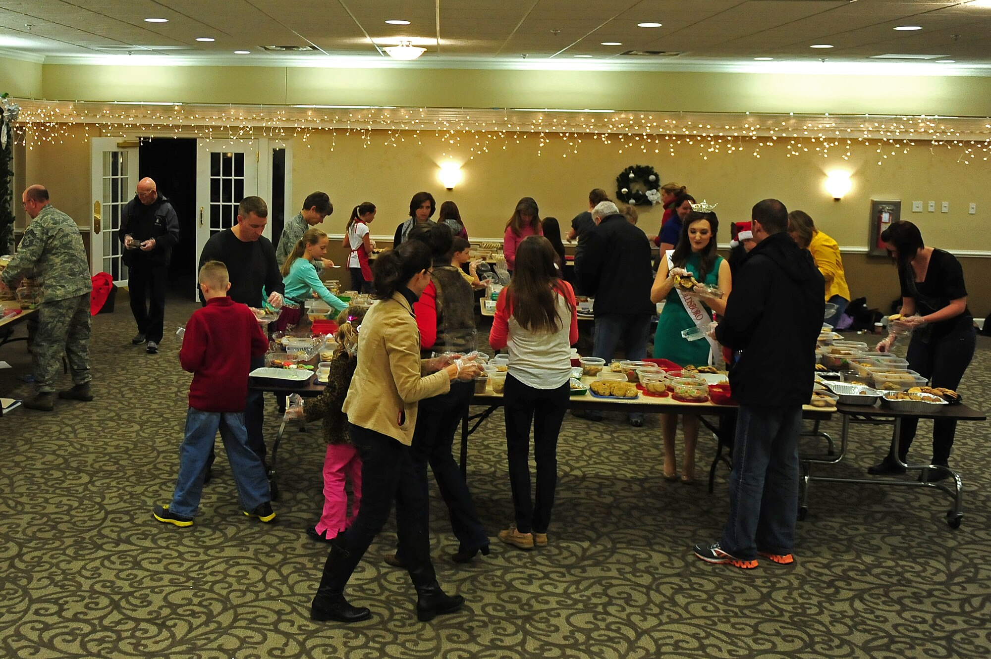 Members of Team Seymour package cookies for the annual Airman Cookie Drive at Seymour Johnson Air Force Base, N.C., Dec. 10, 2013.  The Officer and Civilian Spouses’ Club, a private organization which helps military spouses get involved with the base community, hosted the weeklong event to collect cookies for Airmen living in the dorms to remind them of home during the holiday season.  (U.S. Air Force photo by Airman 1st Class Brittain Crolley)