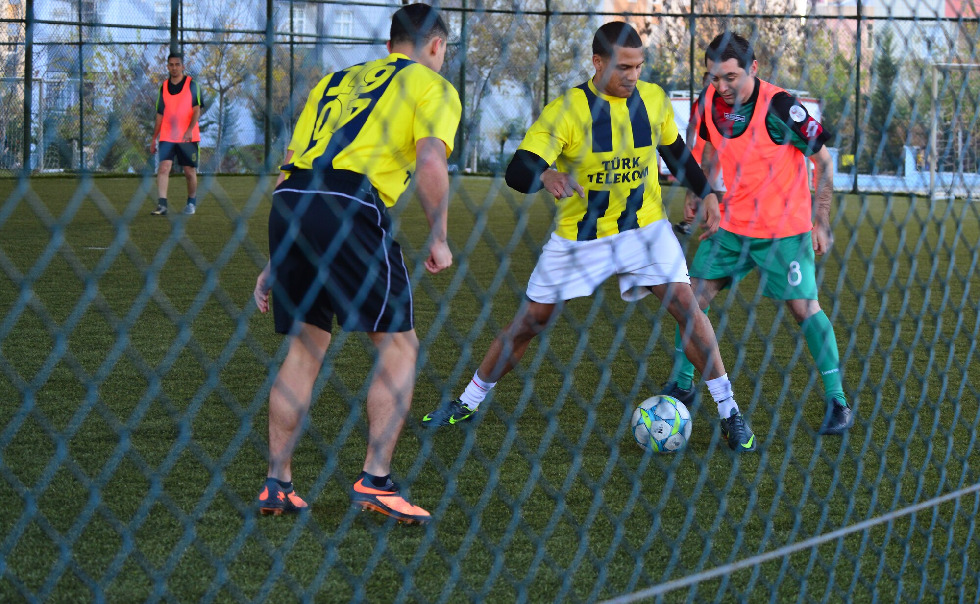 Senior Airman Jerome Cooley, 39th Communications Squadron, places his body in between the ball and an opposing player from Turkish Telecom during a scrimmage match Dec. 6, 2013, at Adana, Turkey. Members of the 39th CS and TT net have been working hand and hand since February to upgrade Incirlik Air Base from DSL internet to fiber. (U.S. Air Force photo by Staff Sgt. Eric Summers Jr./Released)