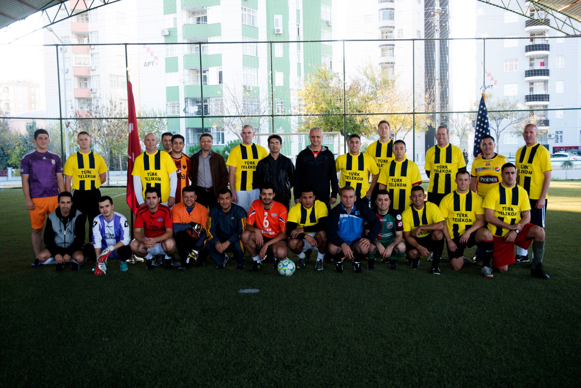Members of the 39th Communications Squadron and Turkish Telecom pose together for a group photo before a soccer match Dec. 6, 2013, at Adana, Turkey.  The soccer game between the two organizations was a way to help foster and grow relationships between Americans and their Turkish counterparts. (U.S. Air Force photo by Staff Sgt. Eric Summers Jr./Released)