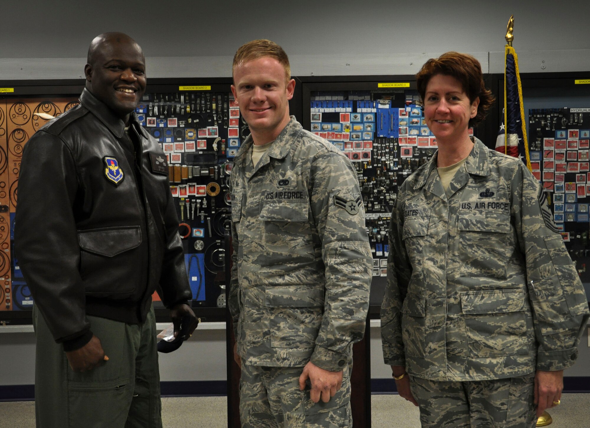 Col. Keith Green, 314th Airlift Wing vice commander, along with Chief Master Sgt. Andrea Gates, 314th AW command chief, congratulate Airman 1st Class Sterling Dixon, a 314th Aircraft Maintenance Squadron aerospace propulsion apprentice, for his selection as Combat Airlifter of the Week Dec. 10 at Little Rock Air Force Base, Ark. Dixon is responsible for maintenance on legacy C-130 aircraft propulsion systems and also immerses himself in various opportunities such as Highway Cleanup and volunteering time for the Airman Family and Readiness Center.  (U.S. Air Force photo by Senior Airman Regina Agoha)
