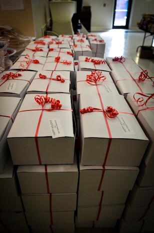 A stack of nearly 500 boxes wait to be shipped to deployed members of Joint Base Charleston, each full of cookies and edible goodies donated by base agencies, volunteers and surrounding local businesses Dec.11, 2013, on Joint Base Charleston — Air Base, S.C. The Team Charleston Spouses Club collected more than 6,500 cookies and edible goods to be distributed to deployed members Joint Base Charleston, the Gaylor Dining Facility and the Naval Weapon Station Galley.  (U.S. Air Force photo/Airman 1st Class Michael Reeves)