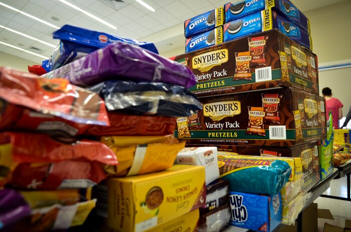 A towering stack of cookies and edible goodies collected by base agencies, volunteers and surrounding local businesses wait to be packaged Dec.11, 2013, at the Chapel Annex on Joint Base Charleston — Air Base, S.C. The Team Charleston Spouses Club collected more than 6,500 cookies and edible goods to be distributed to deployed members Joint Base Charleston, the Gaylor Dining Facility and the Naval Weapon Station Galley. (U.S. Air Force photo/Airman 1st Class Michael Reeves)