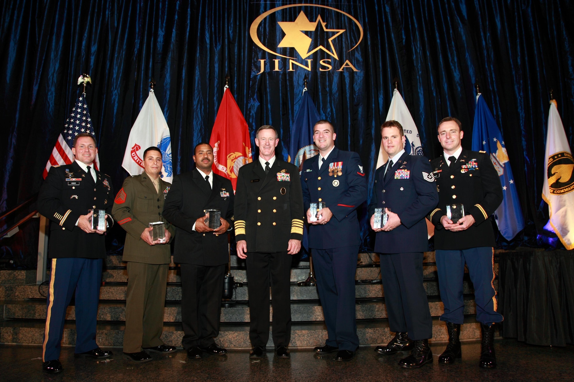 Service members pose for a photo with Adm. William McRaven, U.S. Special Operations Command commander, center, after receiving the Jewish Institute for National Security Affairs Grateful Nation award in Washington, D.C., Dec. 2, 2013. The award is presented annually to six warriors who distinguished themselves through superior conduct and exceptional service. They represent each of the five branches of the military and USSOCOM. (Courtesy photo)