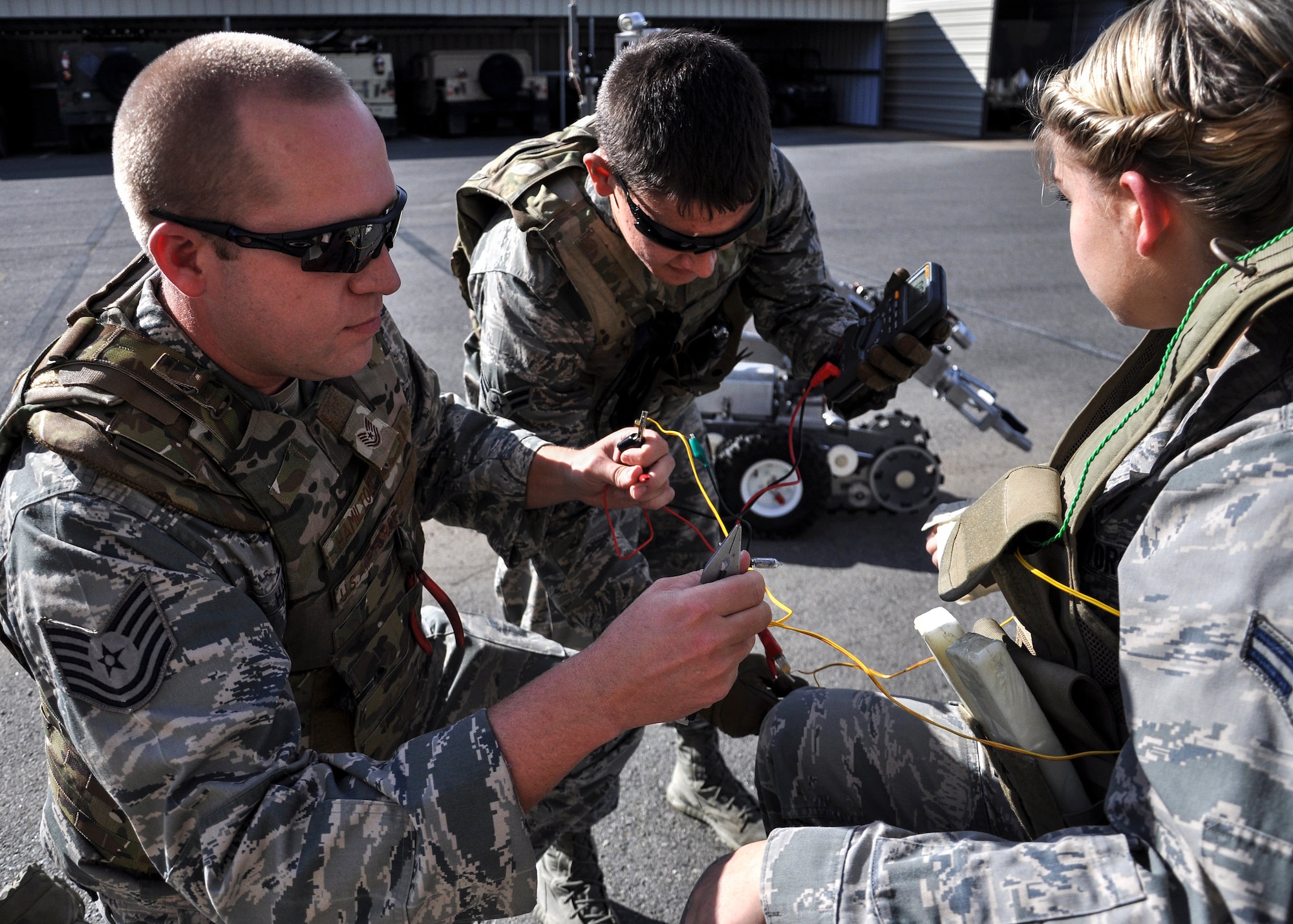 Airman 1st Class Draft Criss, a 19th Civil Engineer Squadron Explosive Ordinance Disposal apprentice and Tech. Sgt. Jacob Hamilton the 19th CES EOD noncommissioned officer in charge, simulate deactivating a timed bomb off the vest of a hostage Nov. 8, 2013, at Little Rock Air Force Base, Ark. The EOD flight trains their Airmen with real-world crisis scenarios; their preparation's intent is to help the Airmen manage stress in an actual crisis. (U.S. Air Force photo by Senior Airman Regina Agoha)