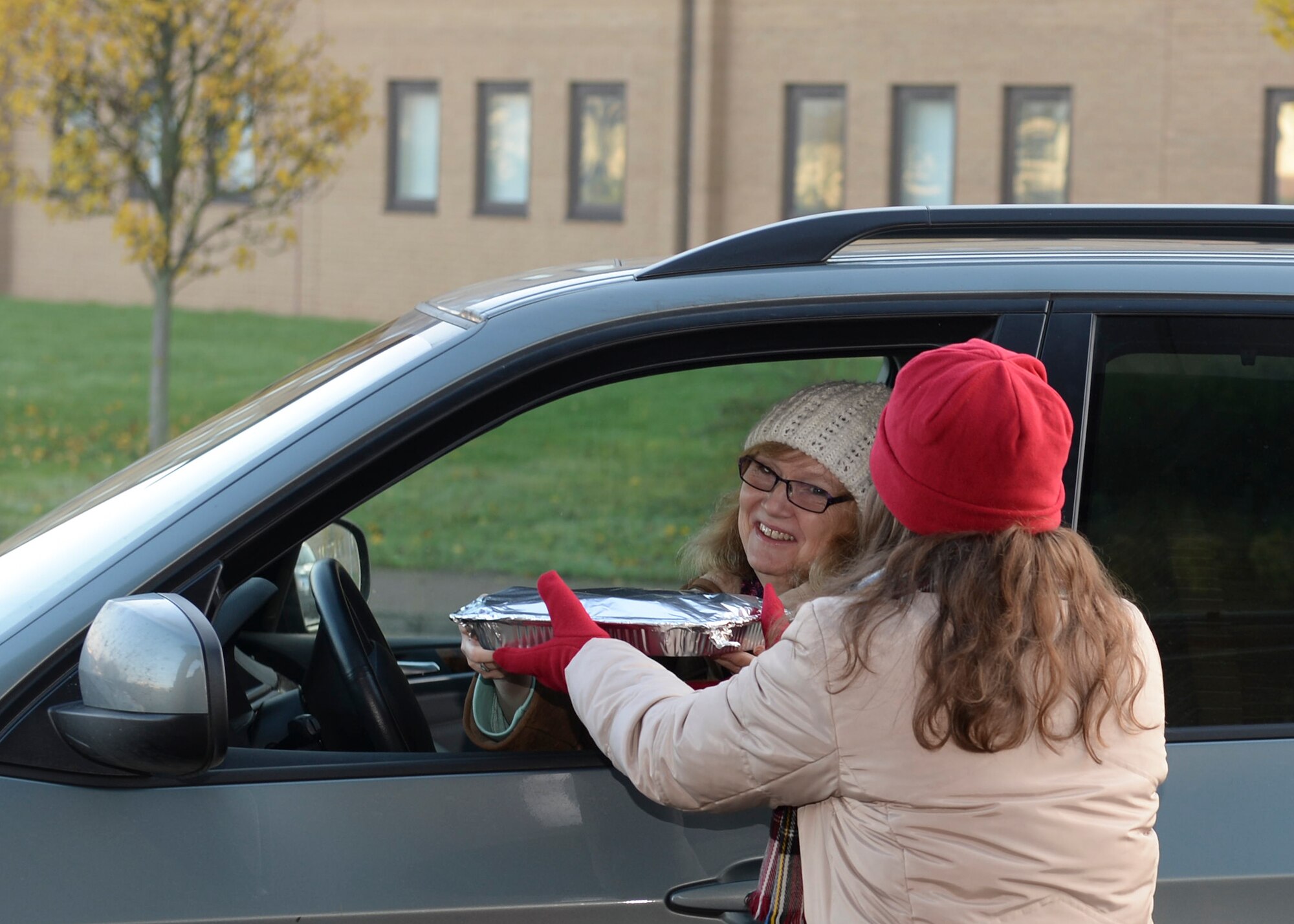 Susan Legan, wife of Col. Joseph Legan, 48th Medical Group commander, drops off homemade cookies for the annual Combat Cookie Drive on Royal Air Force Lakenheath, England, Dec. 11, 2013. The Combat Cookie Drive supplies Airmen who live in the dorms and deployed personnel with a little taste of home during the holiday season. (U.S. Air Force photo by Airman 1st Class Nigel Sandridge/ Released)