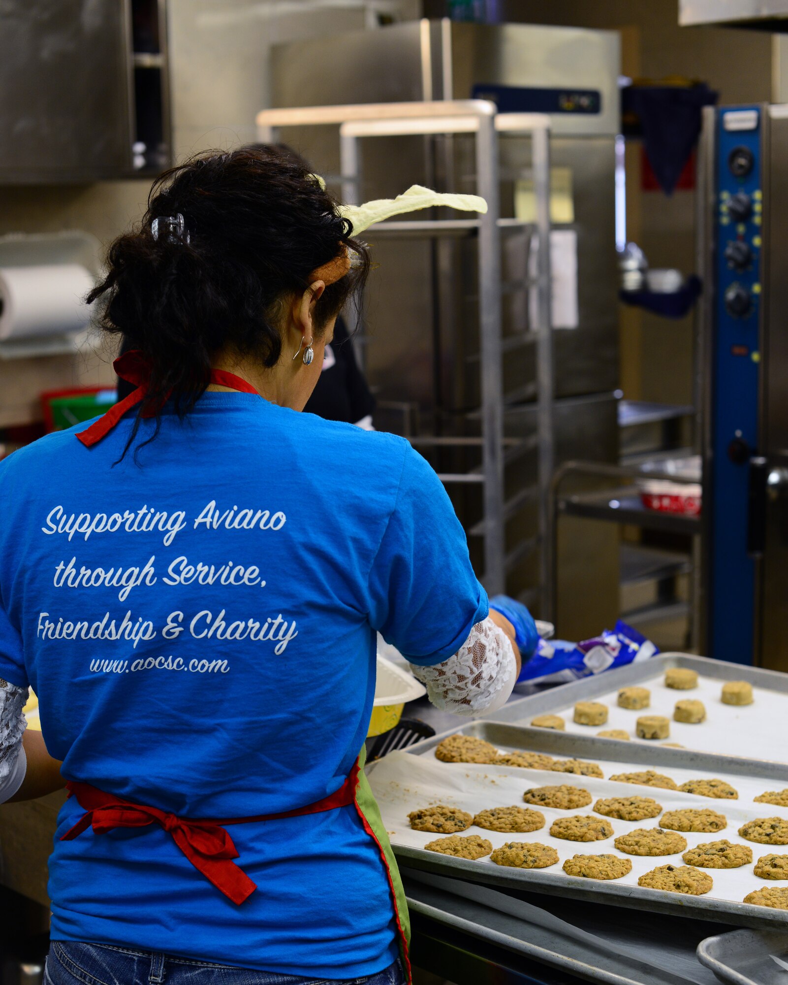 Amber Krowinski, Aviano Officers and Civilian Spouses’ Club president, prepares freshly baked cookies for distribution during the annual Aviano Cookie Drive Dec. 9, 2013, at Aviano Air Base, Italy.  Overall, 10,924 cookies were collected and distributed to U.S. and Italian airmen, Army and Operation Yellow Ribbon. (U.S. Air Force photo/Senior Airman Michael Battles)