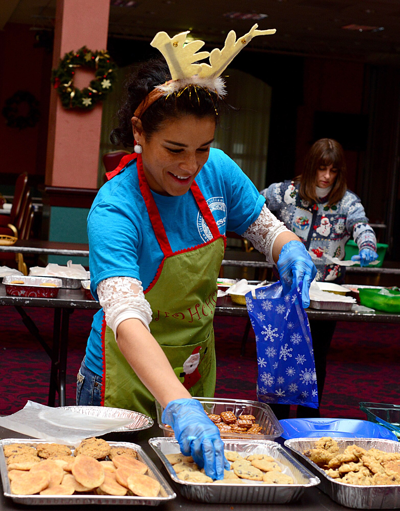 Amber Krowinski, Aviano Officers and Civilian Spouses’ Club president, fills cookie bags during the annual Aviano Cookie Drive Dec. 9, 2013, at Aviano Air Base, Italy. Along with the cookies, volunteers attached a handmade Christmas card collected by the Red Cross and Aviano Elementary School to every bag.   (U.S. Air Force photo/Senior Airman Michael Battles)