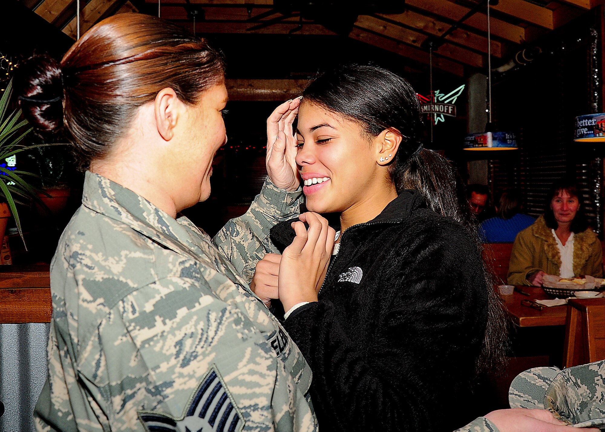 Ali Dollins, daughter of Tech. Sgt. Sabrina Deleon, 436th Maintenance Squadron aerospace ground equipment craftsman, is surprised to see her mother Dec. 10, 2013, at Texas Roadhouse in Dover, Del. Deleon had just returned from a seven-month deployment in an undisclosed location in Southwest Asia. (U.S. Air Force photo/Airman 1st Class Ashlin Federick)