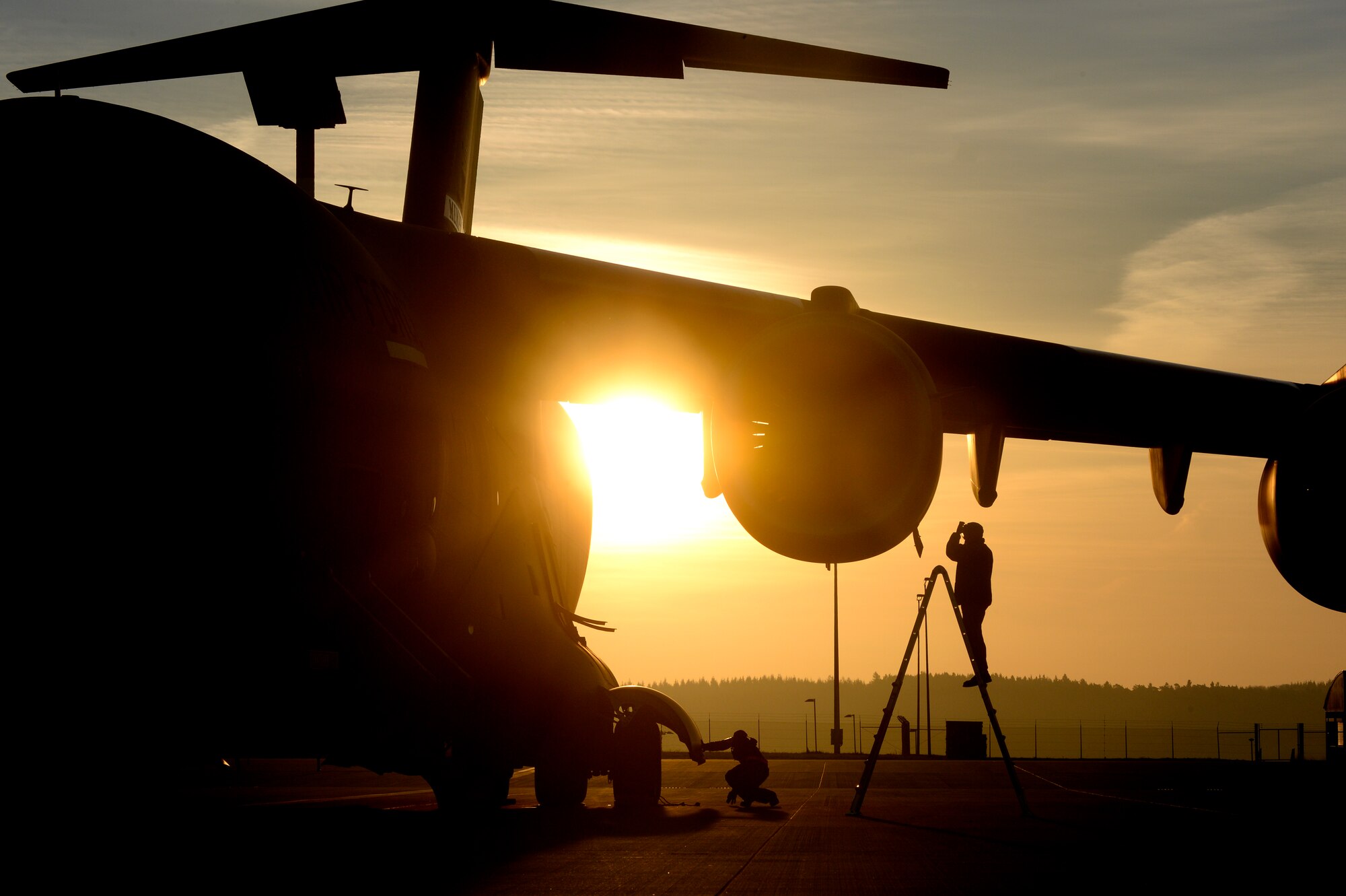 SPANGDAHLEM AIR BASE, Germany -- A crew chief from the 164th Air Wing, Air National Guard out of Memphis, Tenn., services the oil on a C-17 Globemaster III cargo aircraft on the Spangdahlem flightline Dec. 3, 2013. Servicing the oil is part of a thorough flight inspection. (U.S. Air Force photo by Senior Airman Rusty Frank/Released)