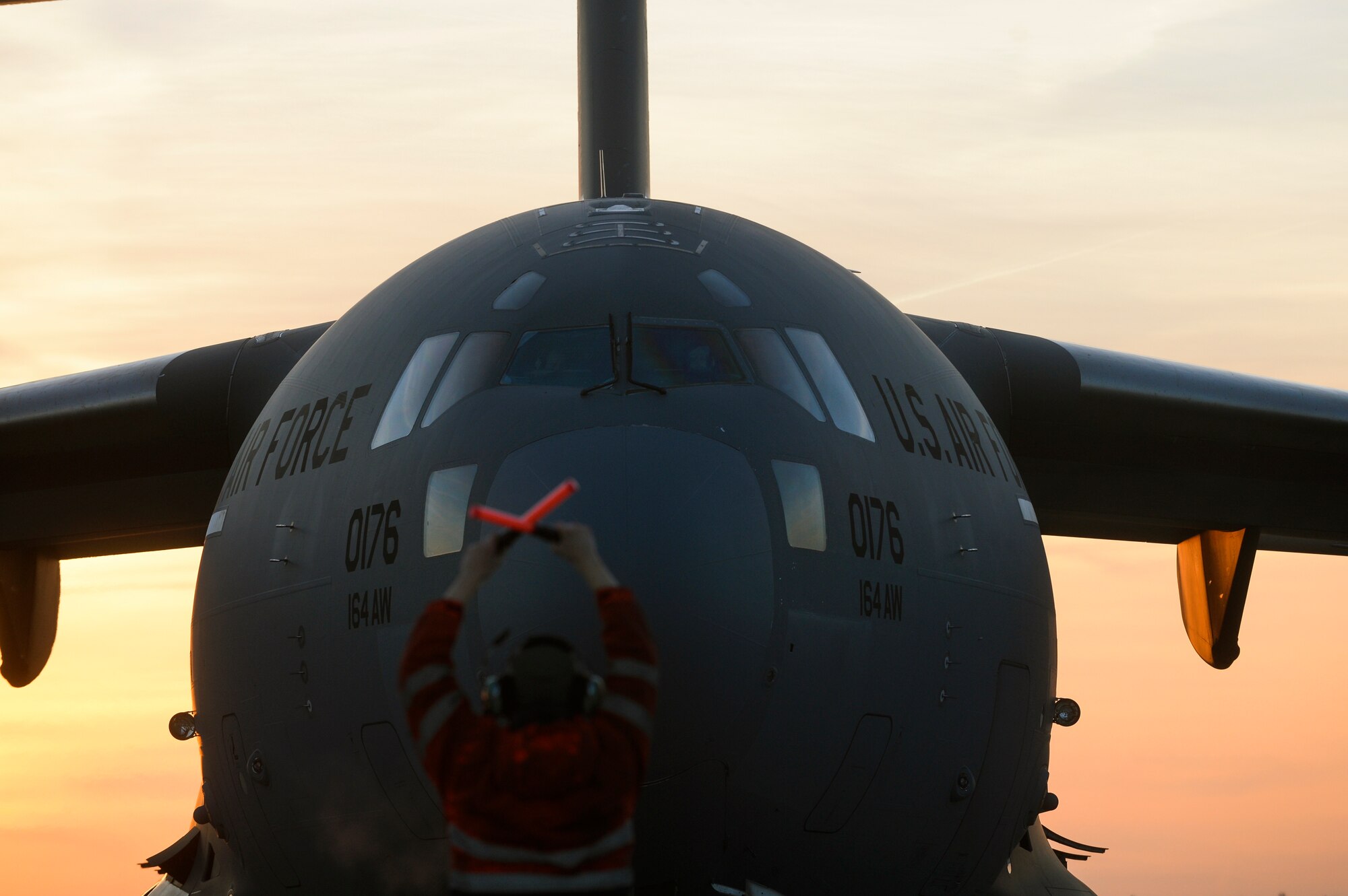 SPANGDAHLEM AIR BASE, Germany -- U.S. Air Force Senior Airman Craig Fox, a 726th Air Mobility Squadron hydraulics maintainer, from Glenn Bernie, Md., marshalls a C-17 Globemaster III cargo aircraft Dec. 3, 2013. The C-17 Globemaster III can carry a maximum payload capacity of 170,900 pounds. (U.S. Air Force photo by Senior Airman Rusty Frank/Released)
