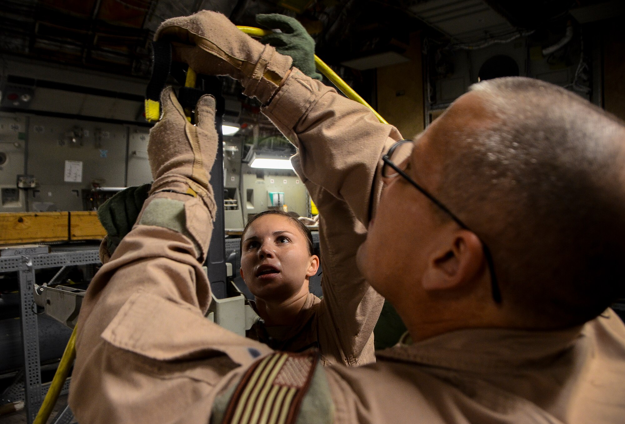 Staff Sgt. Alicia Clark and Tech. Sgt. Robert McNeal secure an electrical system to a litter before an aeromedical evacuation aboard a C-17 Globemaster III at the 379th Air Expeditionary Wing in Southwest Asia, Dec. 9, 2013. Clark and McNeal are 379th Expeditionary Aeromedical Evacuation Squadron aeromedical technicians. Clark is deployed from Ramstein Air Base, Germany and is an Ocala, Fla. native. McNeal is deployed from Charlotte Air National Guard Base, N.C. and hails from Fayetteville, N.C.  (U.S. Air Force photo/Senior Airman Jared Trimarchi)  