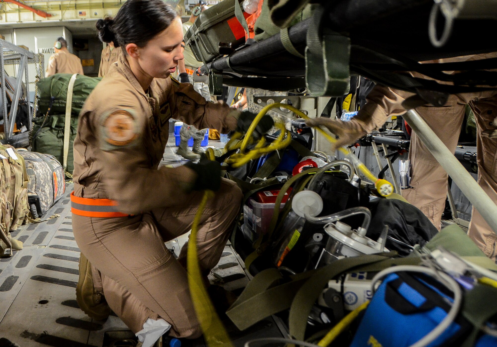 Staff Sgt. Alicia Clark readies medical equipment before an aeromedical evacuation aboard a C-17 Globemaster III at the 379th Air Expeditionary Wing in Southwest Asia, Dec. 9, 2013. Clark, a 379th Expeditionary Aeromedical Evacuation Squadron aeromedical technician, was part of an 8 man team which saved the lives of a Soldier who was suffering from respiratory failure, Dec. 6, 2013. Clark is deployed from Ramstein Air Base, Germany and is an Ocala, Fla. native. (U.S. Air Force photo/Senior Airman Jared Trimarchi)  