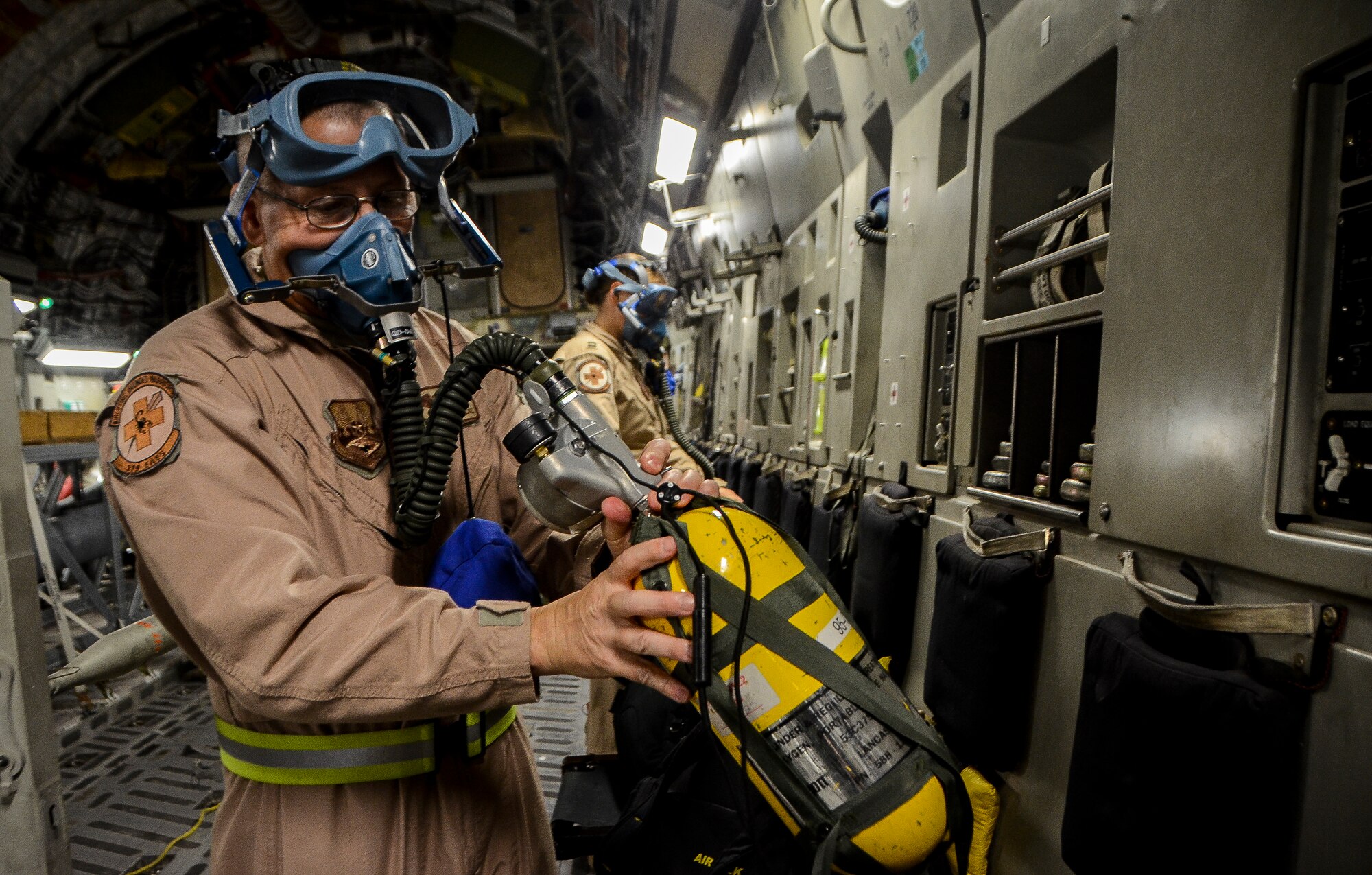 Tech. Sgt. Robert McNeal tests a portable oxygen tank before an aeromedical evacuation aboard a C-17 Globemaster III, at the 379th Air Expeditionary Wing in Southwest Asia, Dec. 9, 2013. McNeal, a 379th Expeditionary Aeromedical Evacuation Squadron aeromedical technician, was part of an 8 man team which saved the lives of a Soldier who was suffering from respiratory failure, Dec. 6, 2013. Clark is deployed from Charlotte Air National Guard Base, N.C. and hails from Fayetteville, N.C. (U.S. Air Force photo/Senior Airman Jared Trimarchi)  